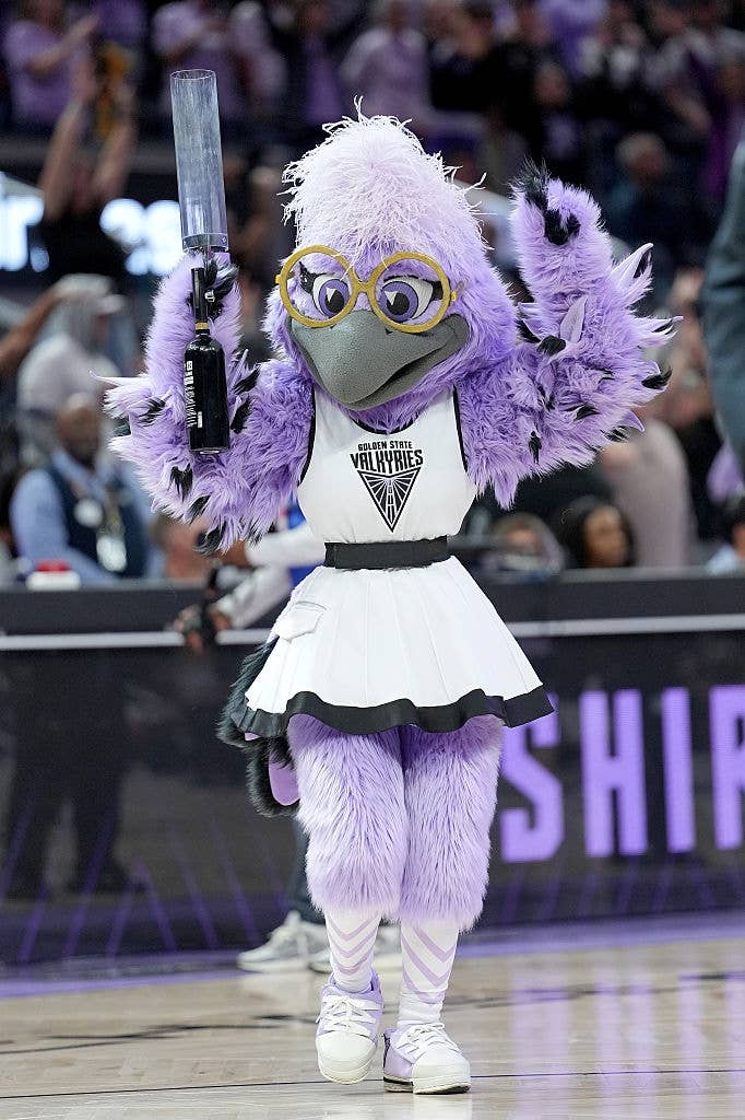 A sports squad  mascot successful  a cheerleader outfit performs connected  a hoops  court, energizing the assemblage  during a game