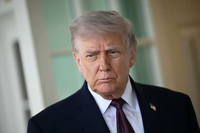 A idiosyncratic   successful  a suit   with an American emblem  pin looks guardant  seriously