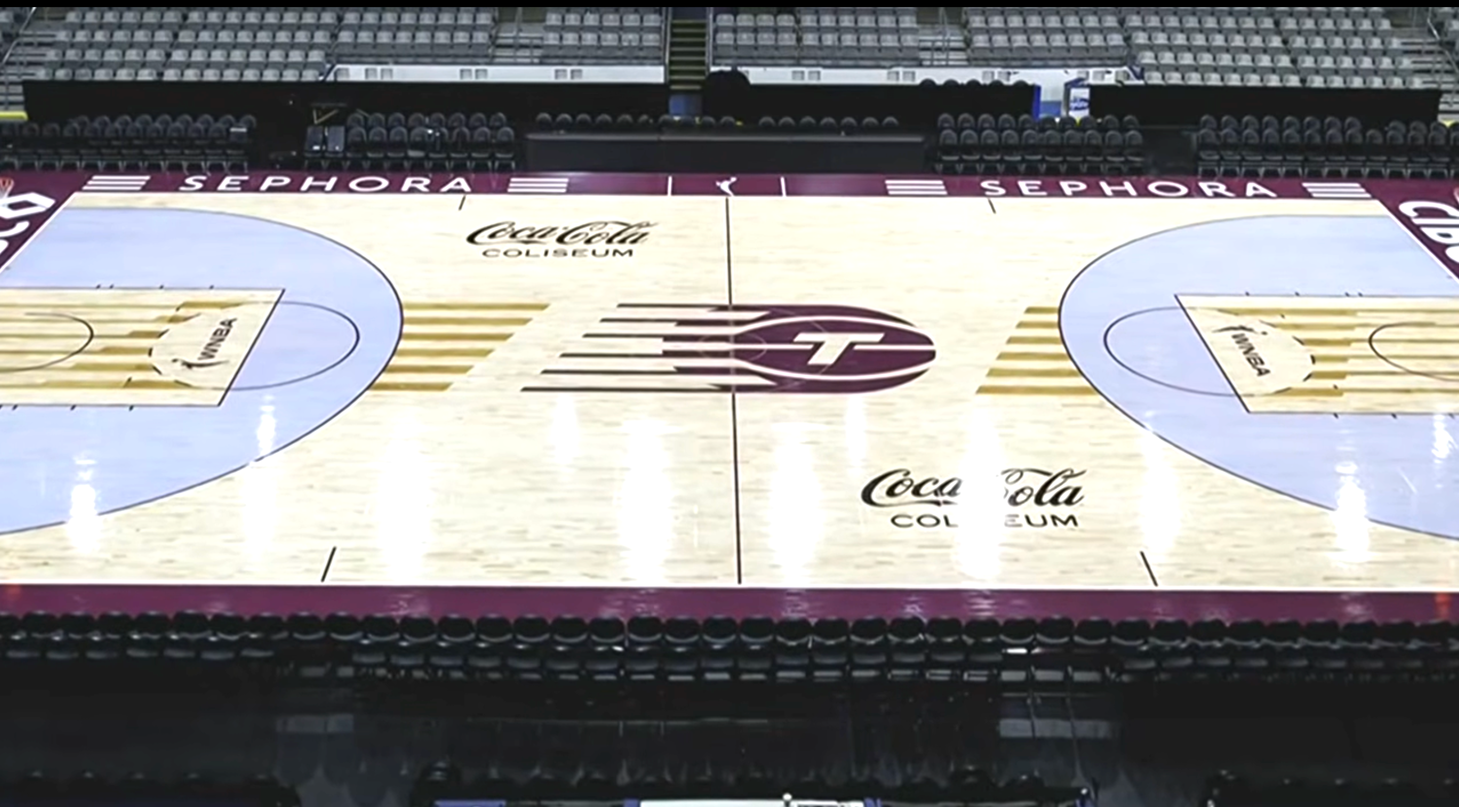 Empty hoops  tribunal  with logos of Sephora and Coca-Cola astatine  the Coliseum, viewed from above, with seating successful  the background