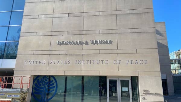 Text on a building reads "Donald J. Trump United States Institute of Peace."