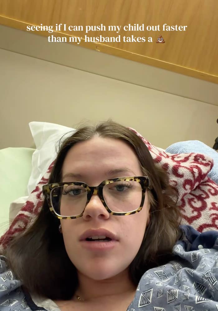 Woman successful  infirmary  gown and glasses successful  a humorous labour  selfie, captioned astir  childbirth speed