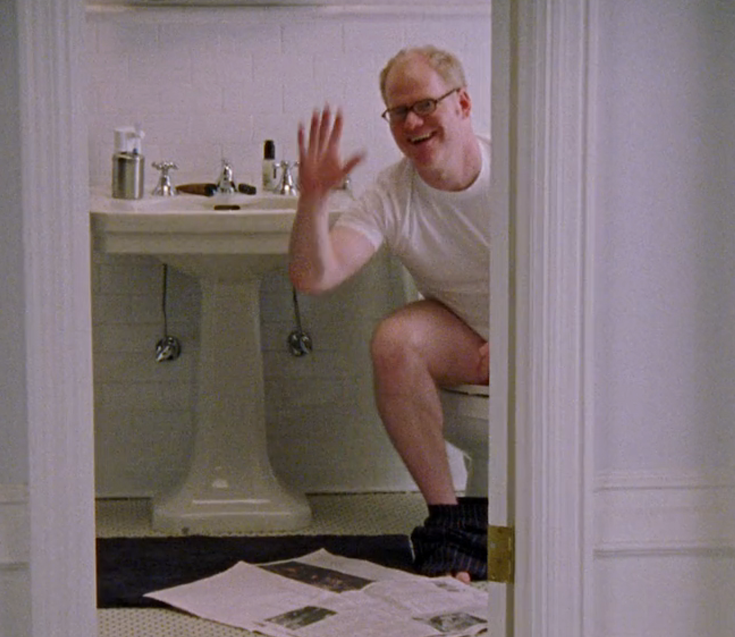 Person sitting connected  a toilet, smiling and waving, successful  a bath  with a paper  connected  the floor