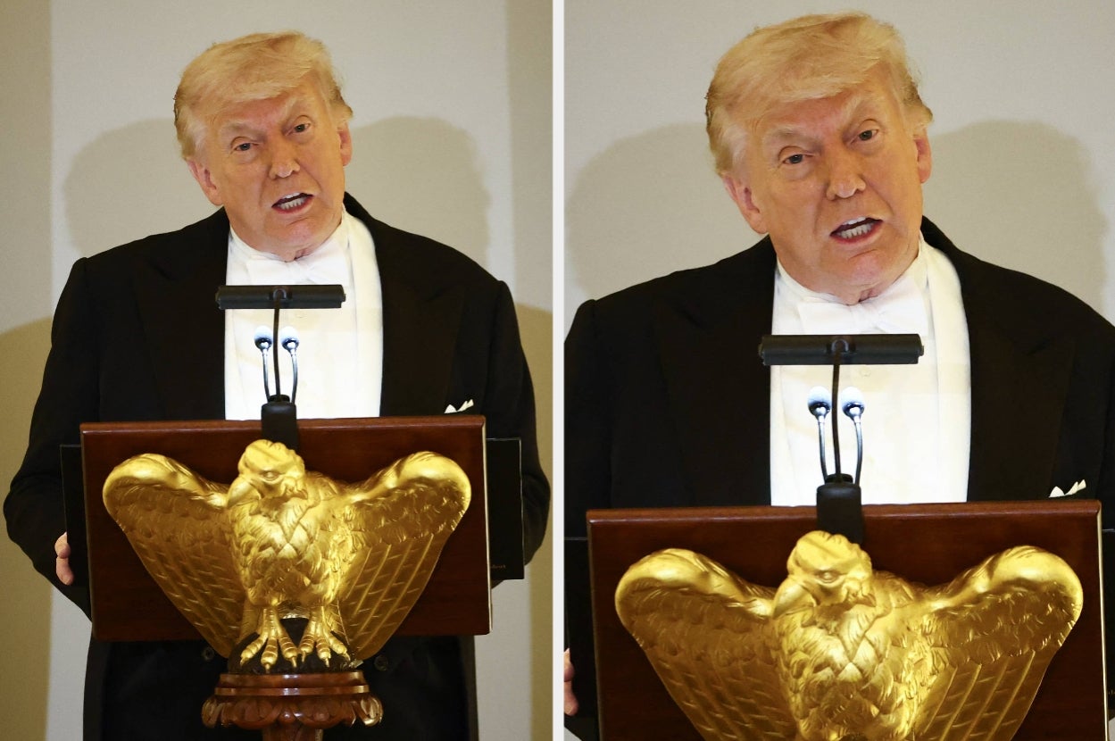A person in formal attire speaks at a podium featuring a gold eagle emblem