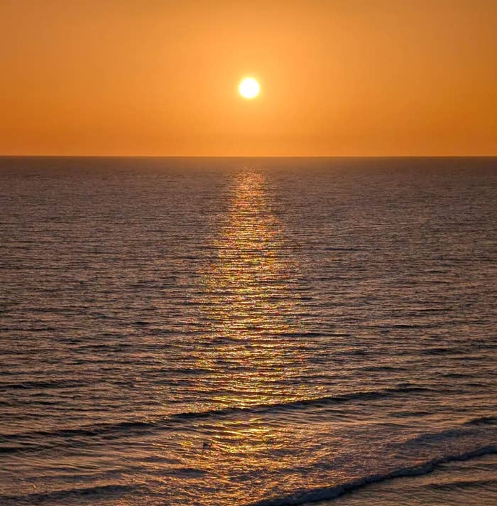 Screenshot of a Reddit post titled "San Diego sunset," showing an ocean view with the sun setting on the horizon
