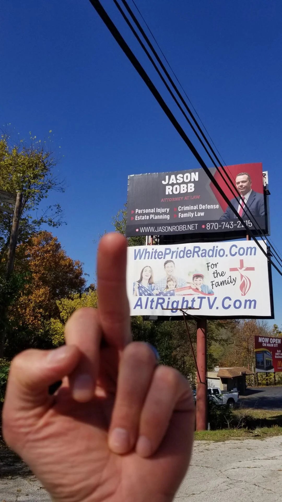 A idiosyncratic   shows a mediate  digit  to a billboard for Jason Robb, with a vigor   and TV website for "Alt Right" and "White Pride" shown below