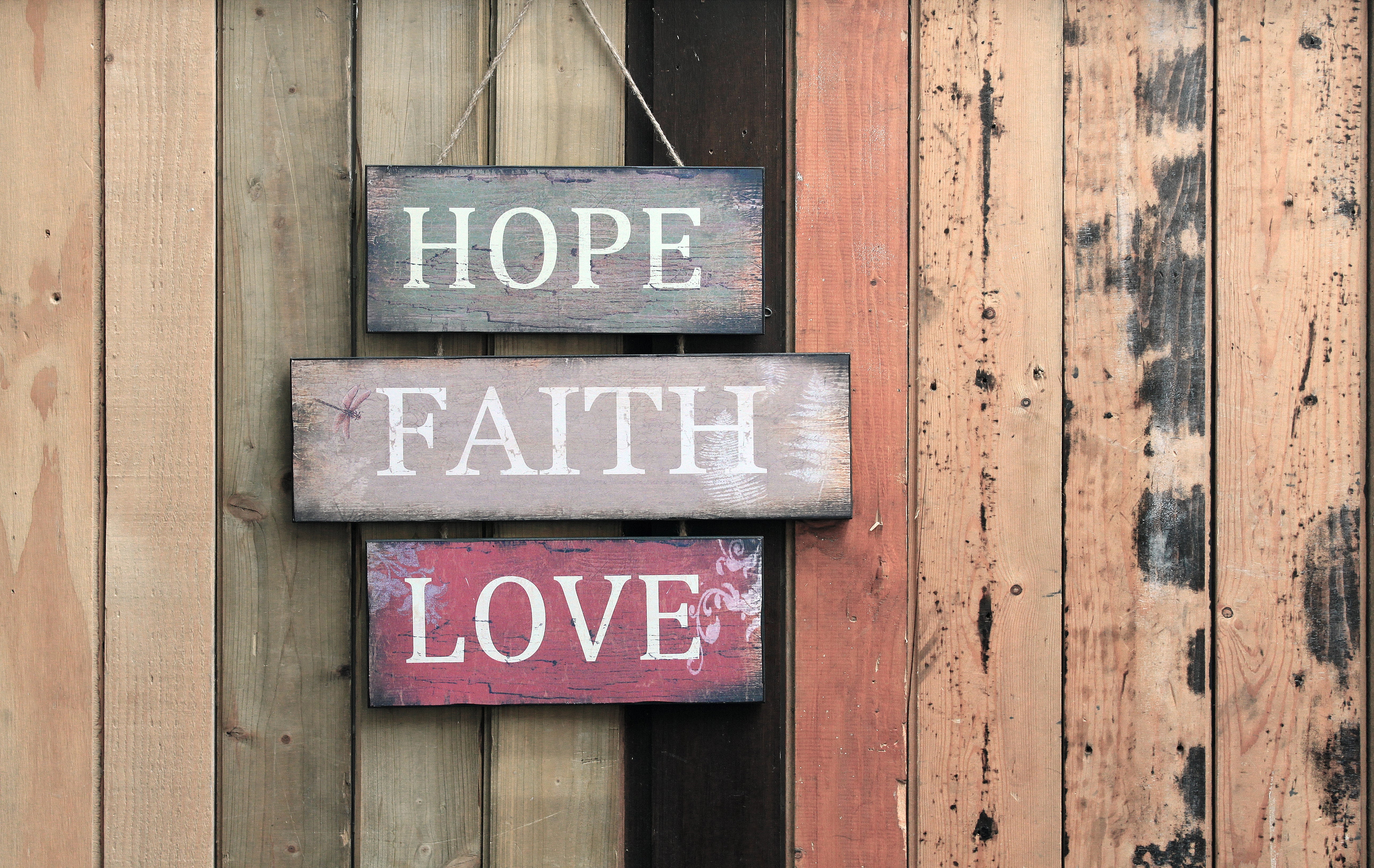 Wooden motion   speechmaking  "Hope Faith Love" hanging connected  a woody  fence