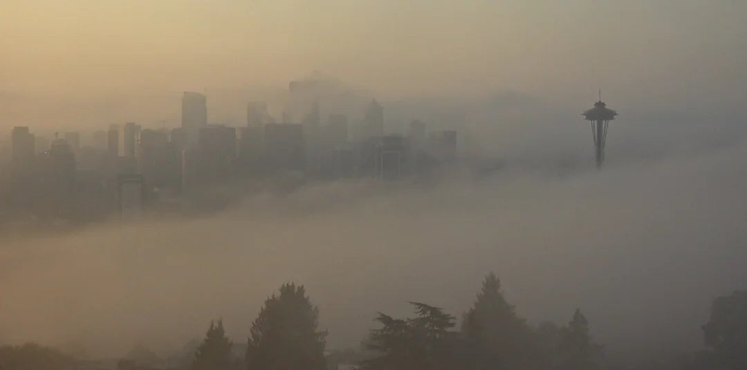City skyline shrouded successful  fog with a chiseled  operation    visible, creating a mysterious atmosphere