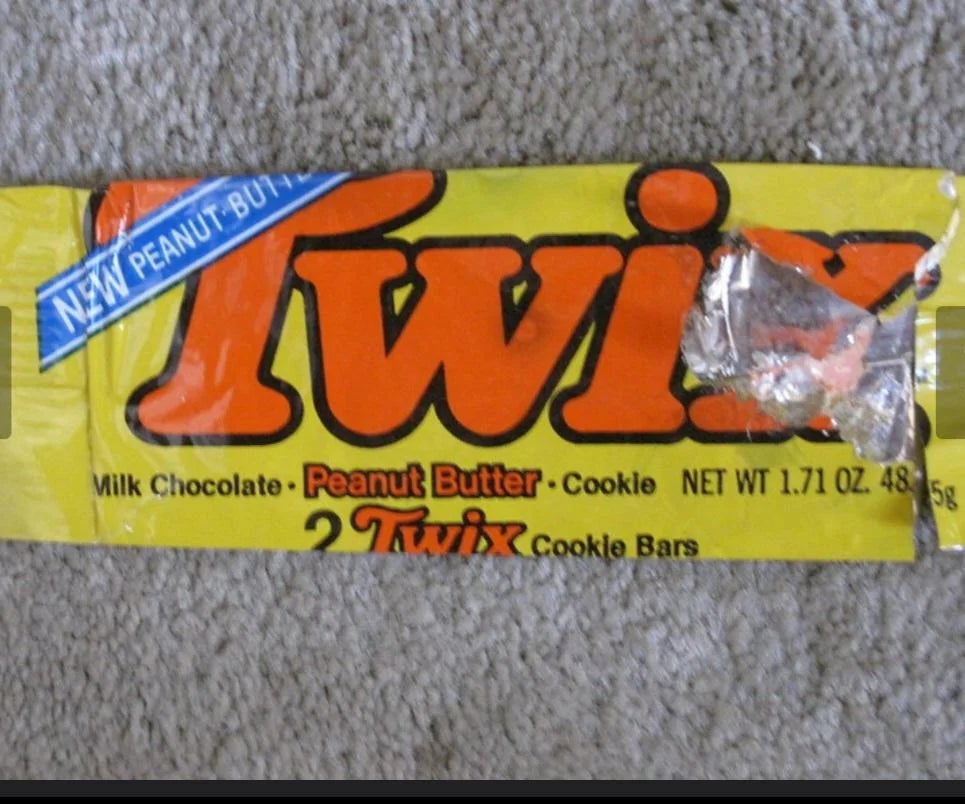 Twix Peanut Butter wrapper showing two bar package. Wrapper is open with part of the right corner missing
