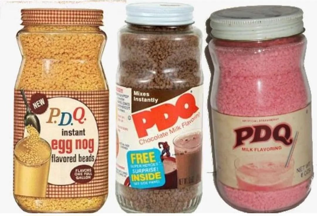 Three jars of PDQ drink mixes: eggnog flavored beads, chocolate milk crystals, and milk flavoring granules
