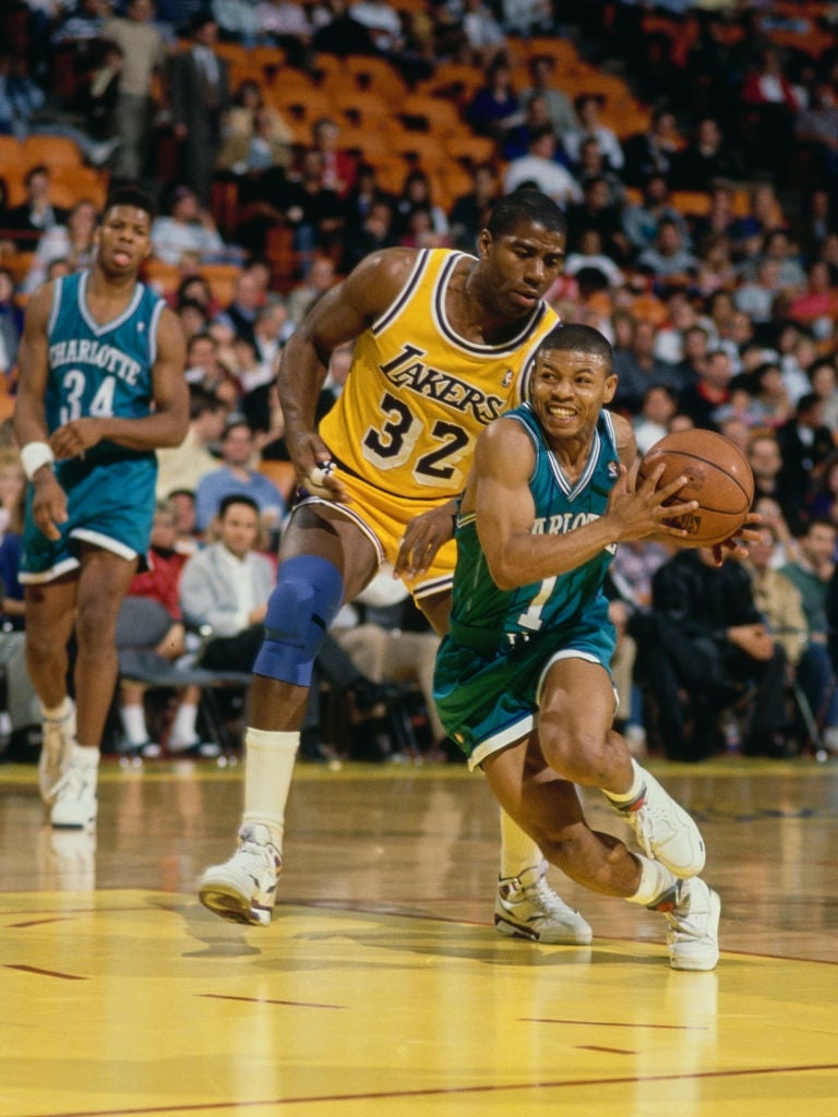 Basketball players successful  enactment   during a game; 1  dribbling portion    different  defends closely