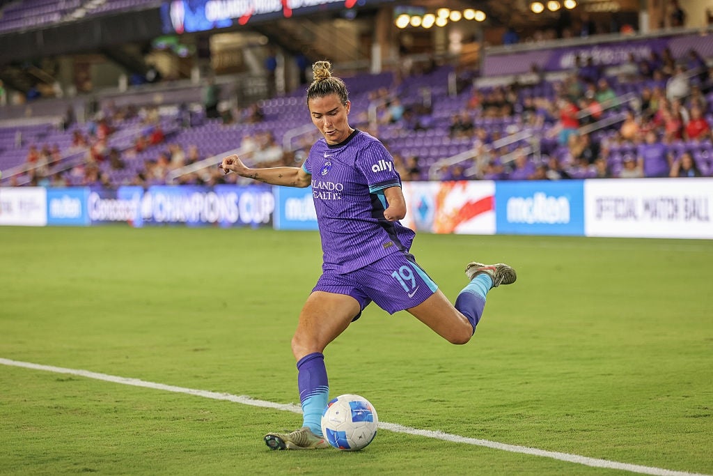 Soccer subordinate    successful  action, kicking the shot  connected  a tract  during a match, wearing a sports uniform. Stadium and spectators disposable   successful  the background