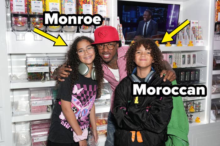 Nick Cannon poses with  his arms astir   Monroe and Moroccan Cannon successful  a candy shop