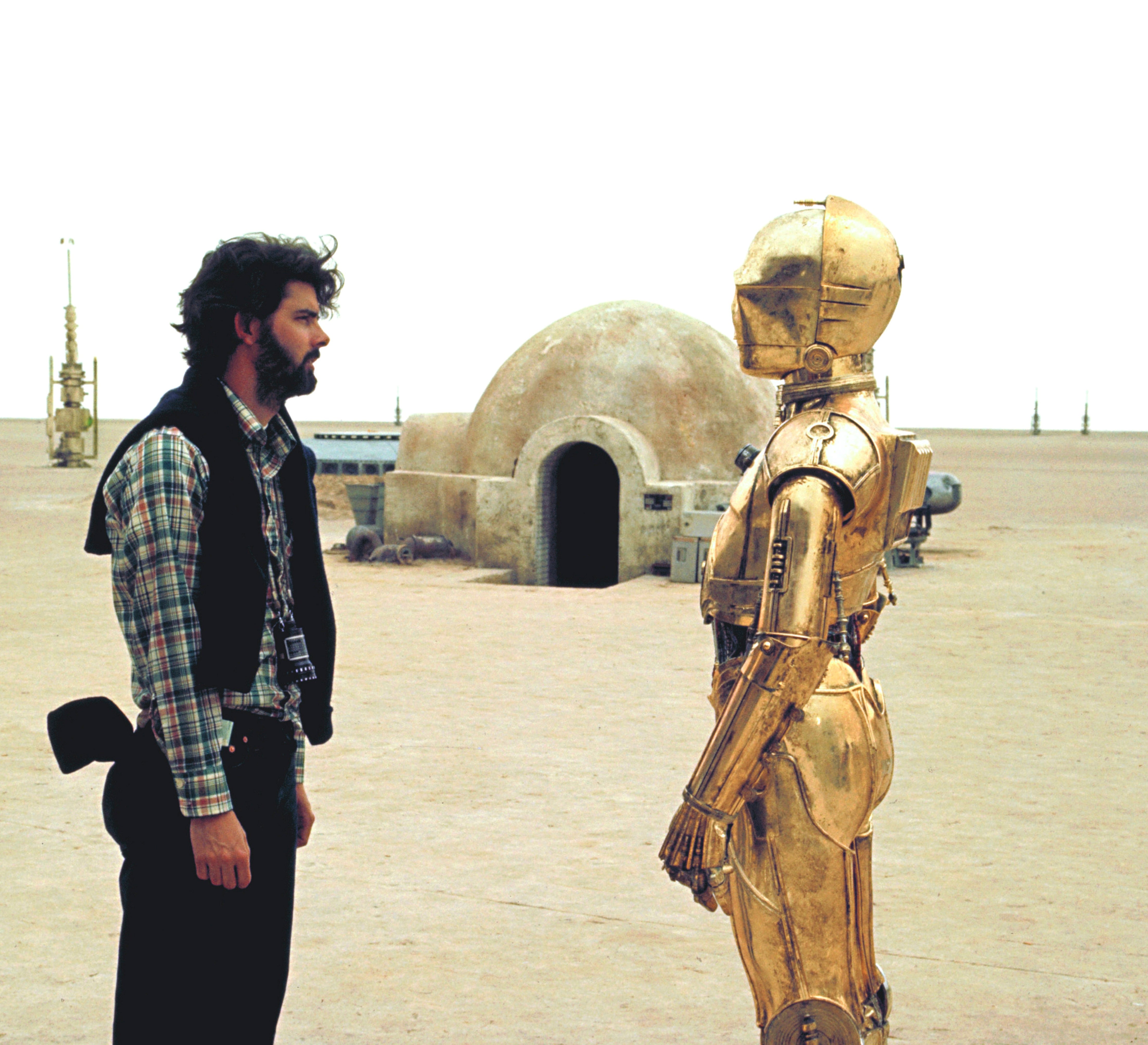 A idiosyncratic   connected  a movie  acceptable   faces a humanoid robot successful  a godforsaken  situation  with a dome-shaped gathering  successful  the background