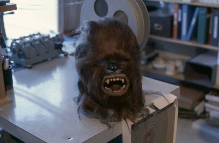 Wookiee caput  prop from a movie  set, featuring elaborate  fur and teeth, placed connected  a array  successful  a store   setting