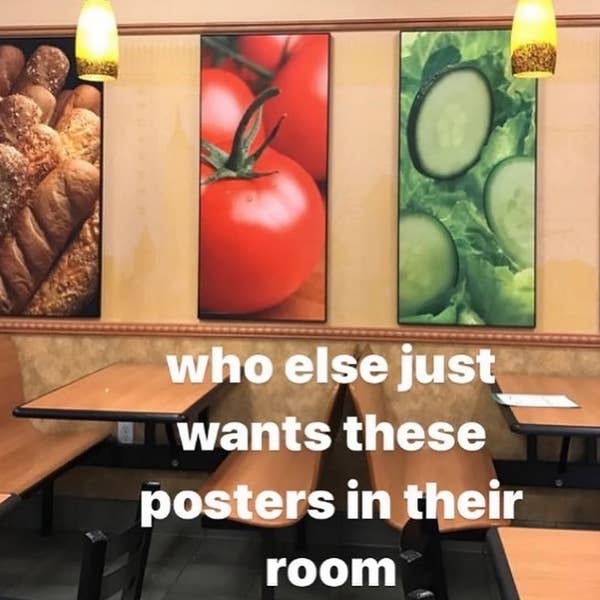 Restaurant interior with wall posters of bread, tomatoes, and cucumbers above seating. Text reads, "who else just wants these posters in their room"