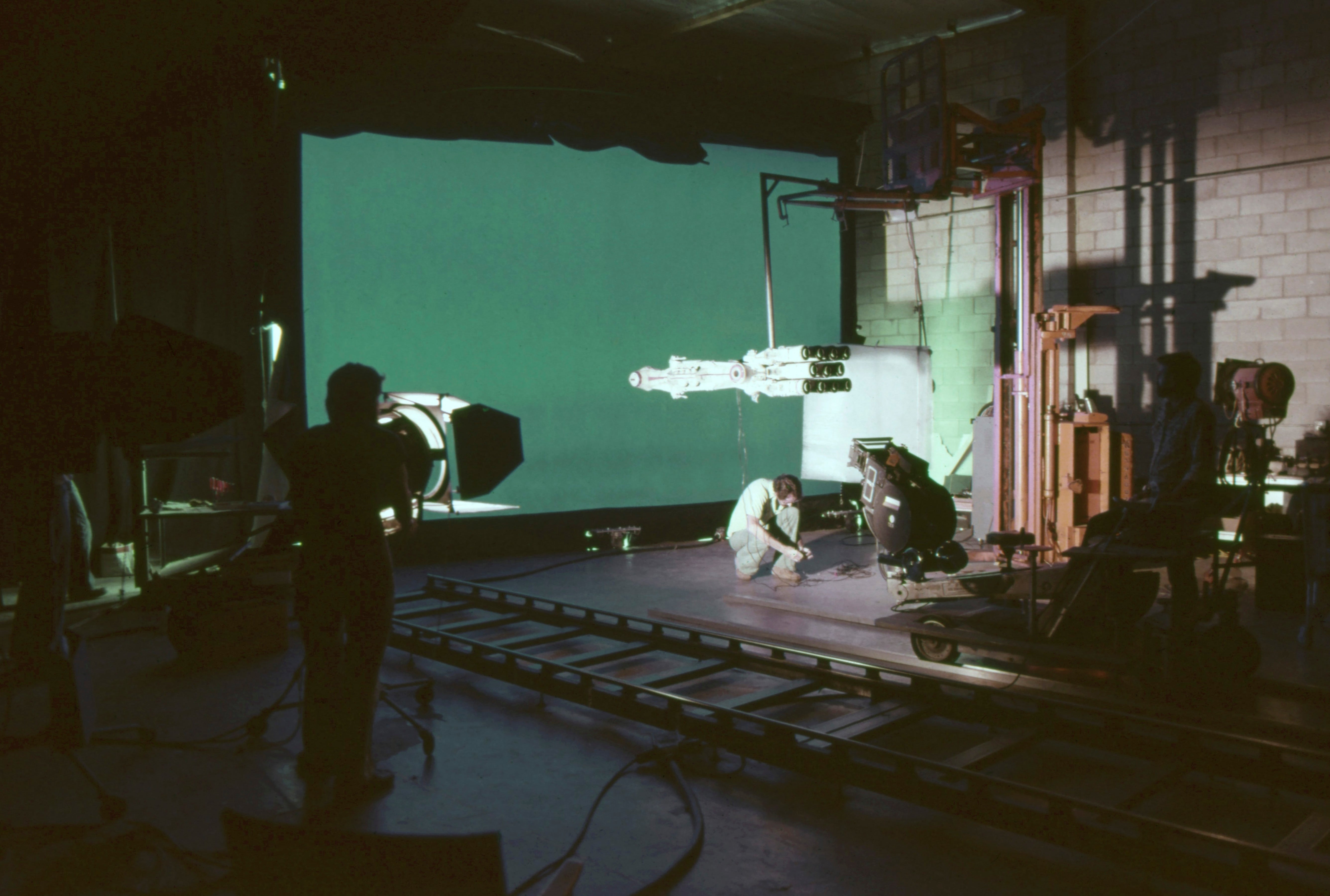 Film unit  connected  acceptable   with camera, lighting equipment, and props, capturing a scene. A idiosyncratic   adjusts instrumentality  successful  a workplace  setting