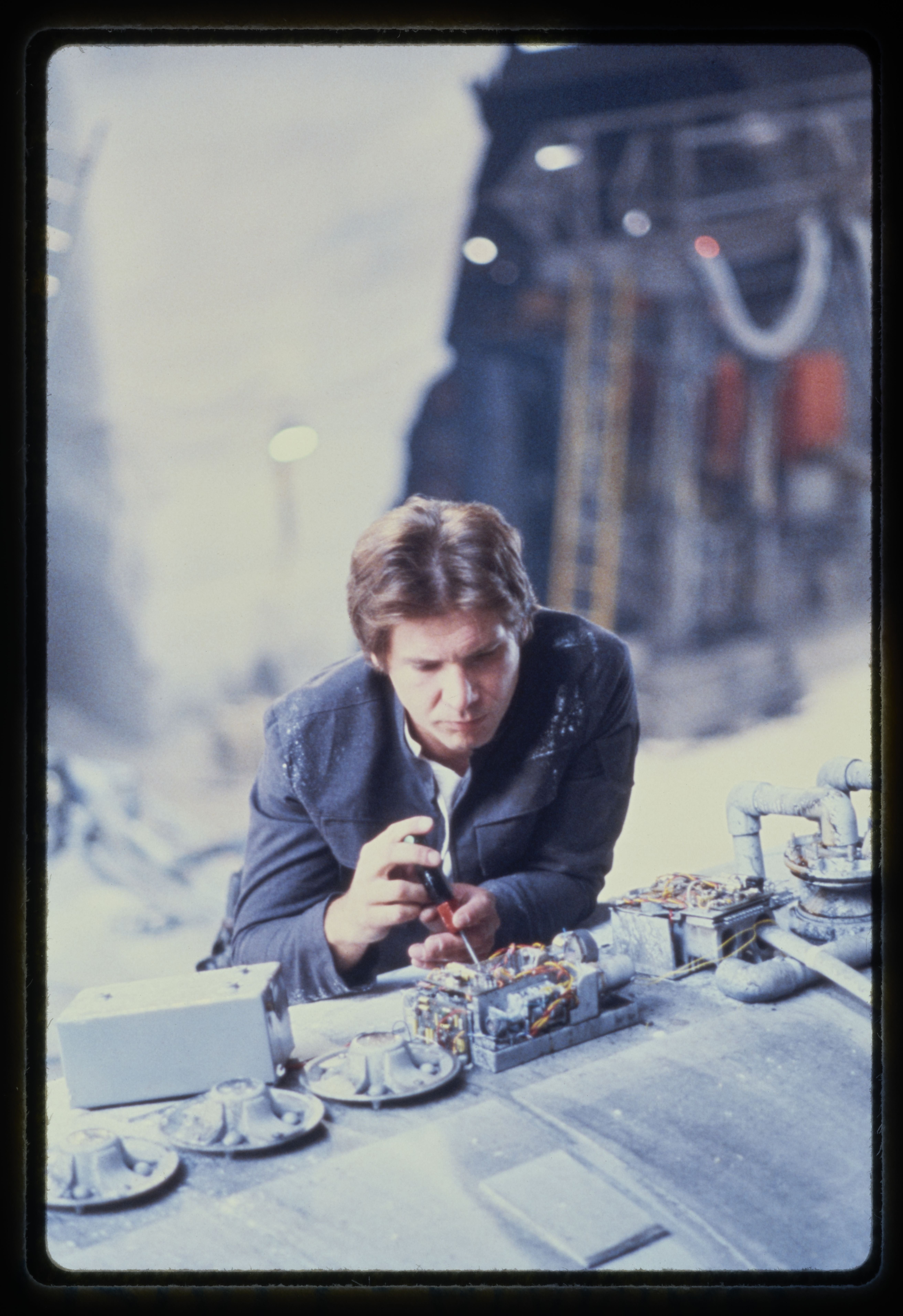Man successful  futuristic mounting  works   connected  machinery, appearing focused and engaged, suggesting a sci-fi movie  scene