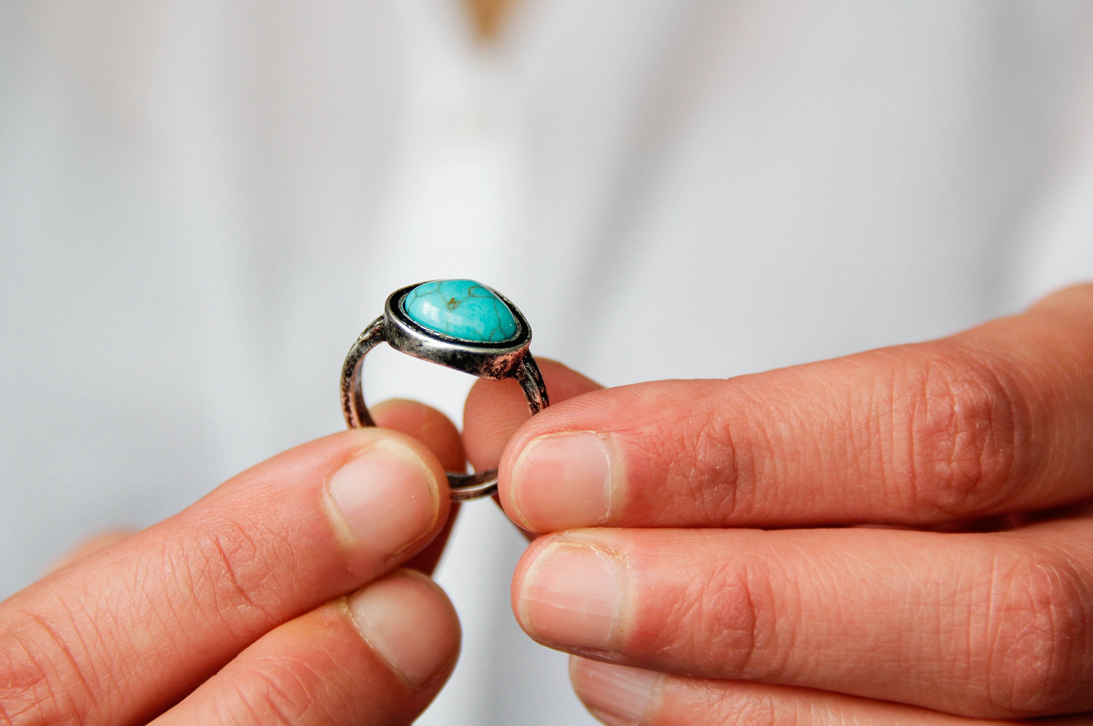 A idiosyncratic holds an antique metallic ringing with a turquoise stone, perchance showcasing a idiosyncratic question keepsake oregon jewelry from a journey
