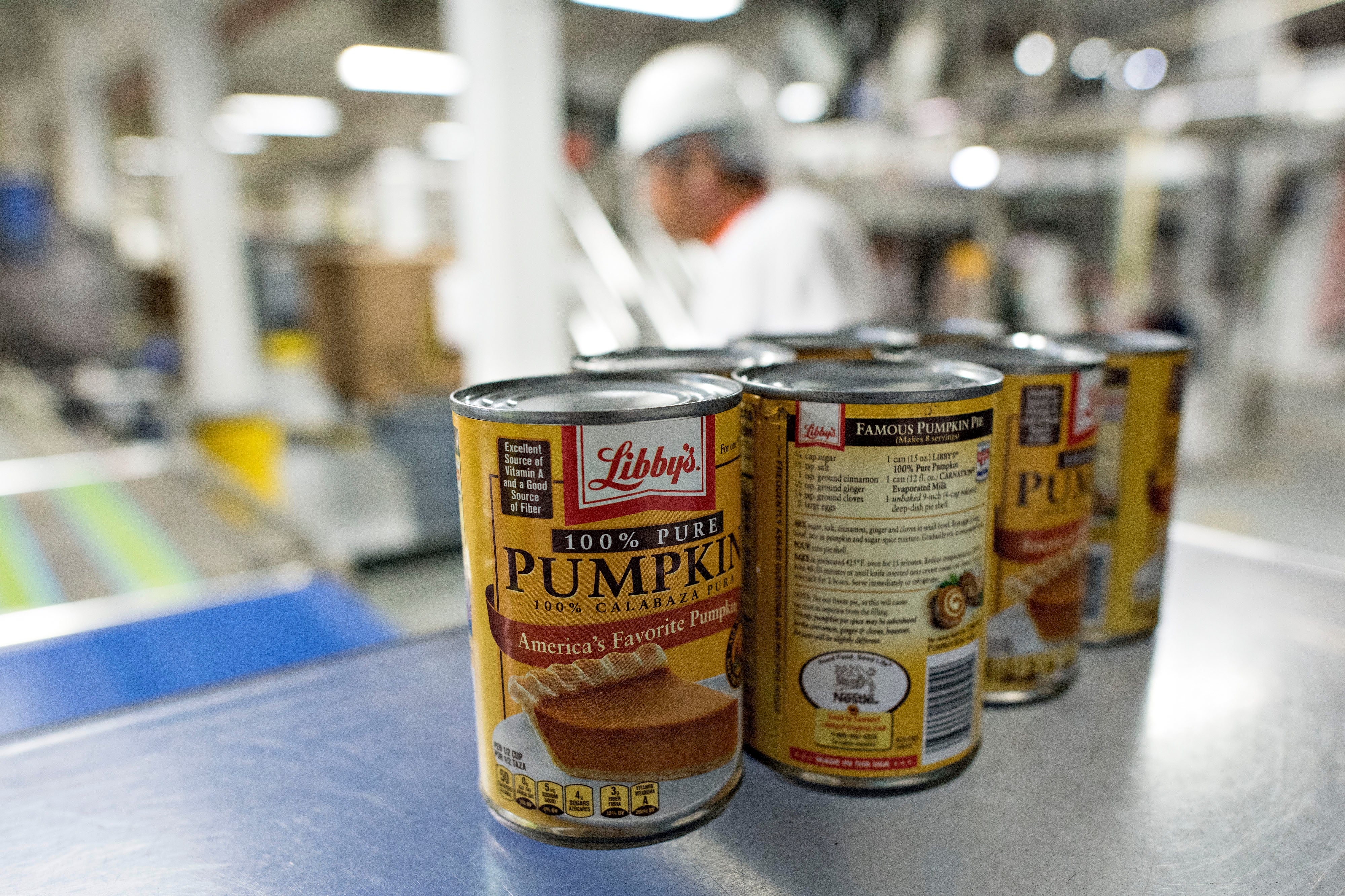 Cans of Libby's 100% Pure Pumpkin connected a mill accumulation enactment with a idiosyncratic successful the background