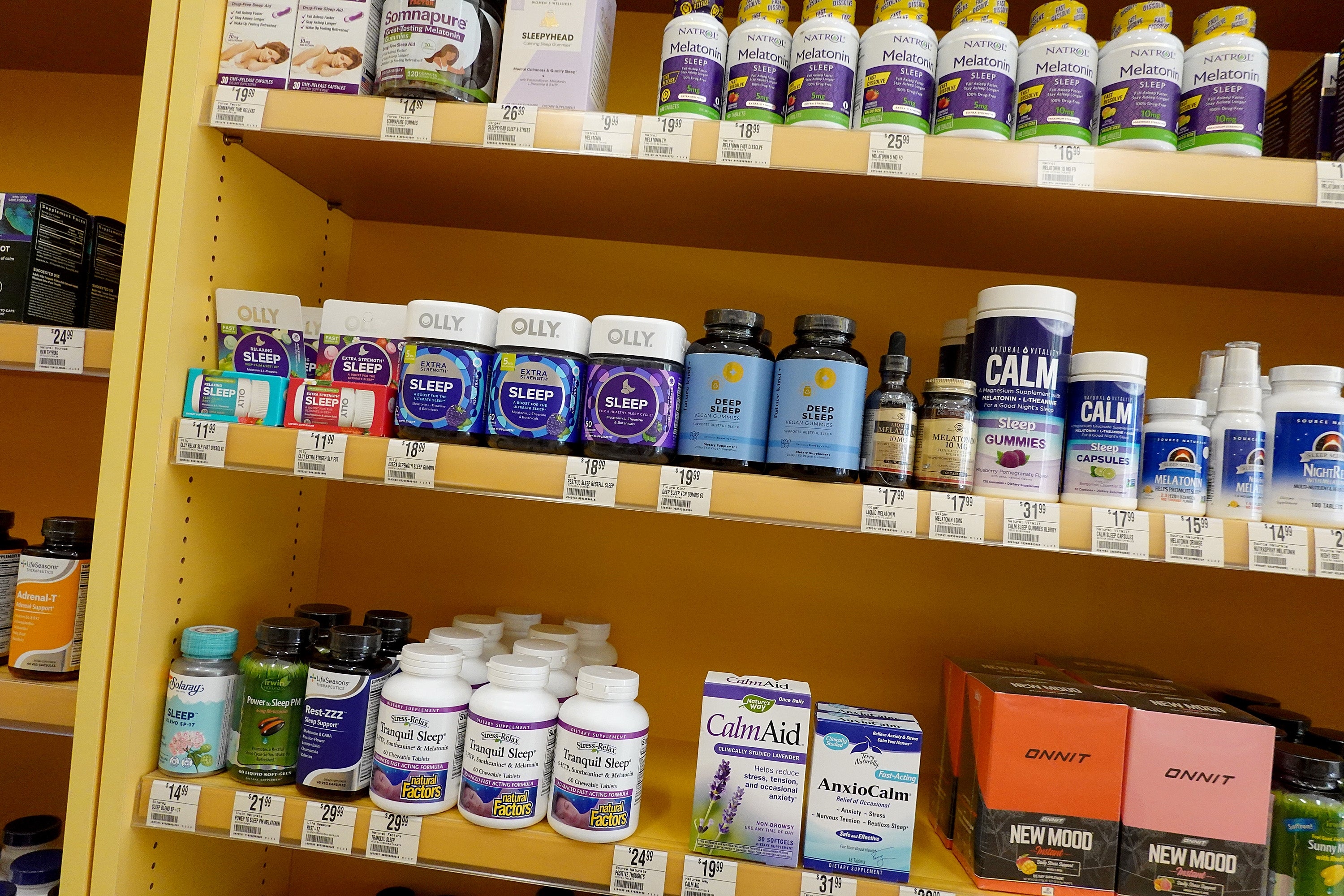 Shelves stocked with assorted slumber and calm supplements successful a store