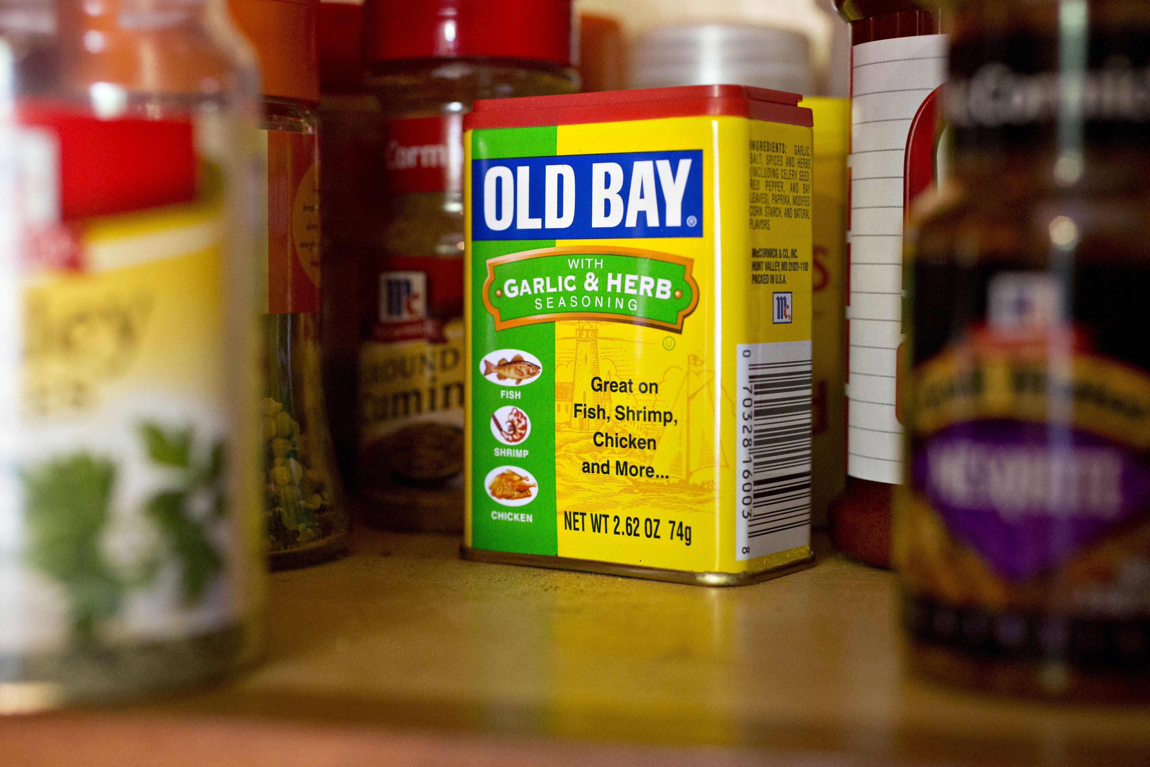Various spice containers successful a room cabinet, featuring a salient Old Bay seasoning with ail and herb blend