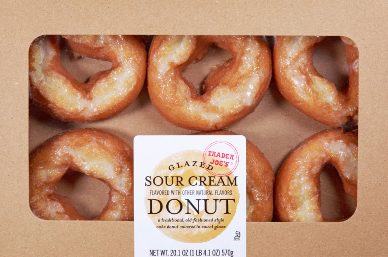 Box of six glazed sour cream donuts visible through a window in the packaging