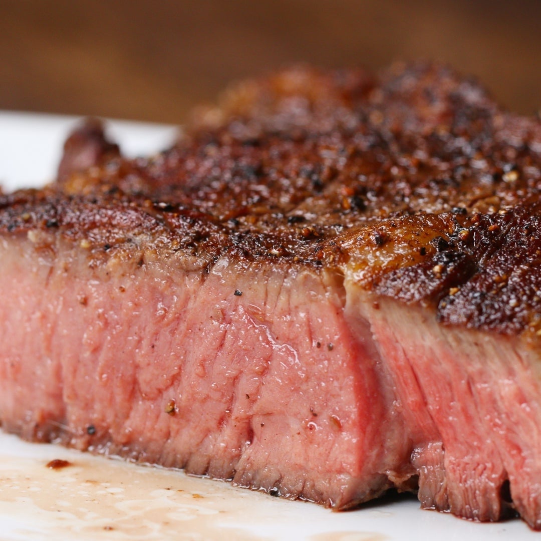 Juicy, medium-rare steak connected  a plate, showcasing a seared, seasoned crust