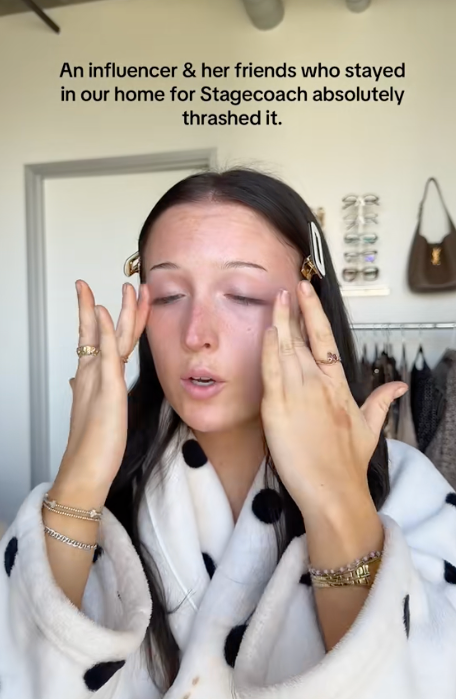 Person applying makeup, wearing a polka dot robe, with substance   astir  cleaning up   aft  influencer guests post-Stagecoach