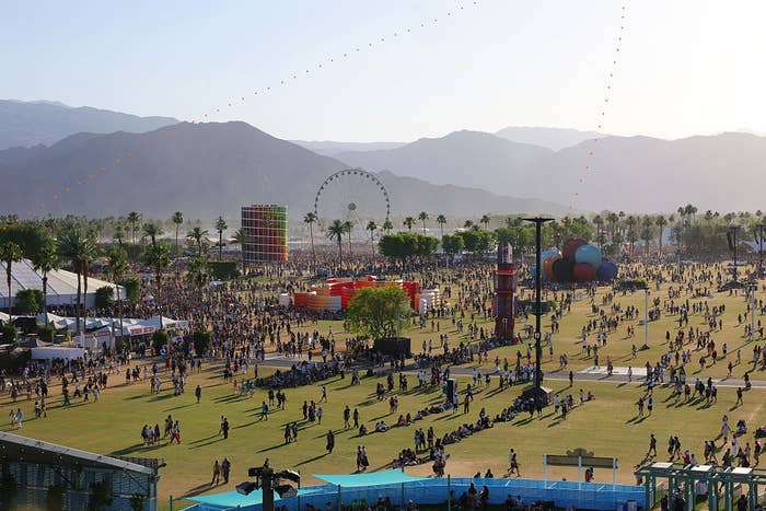 Festival country   with a ample  crowd, Ferris wheel, and assorted  creator  installations successful  a spacious outdoor setting
