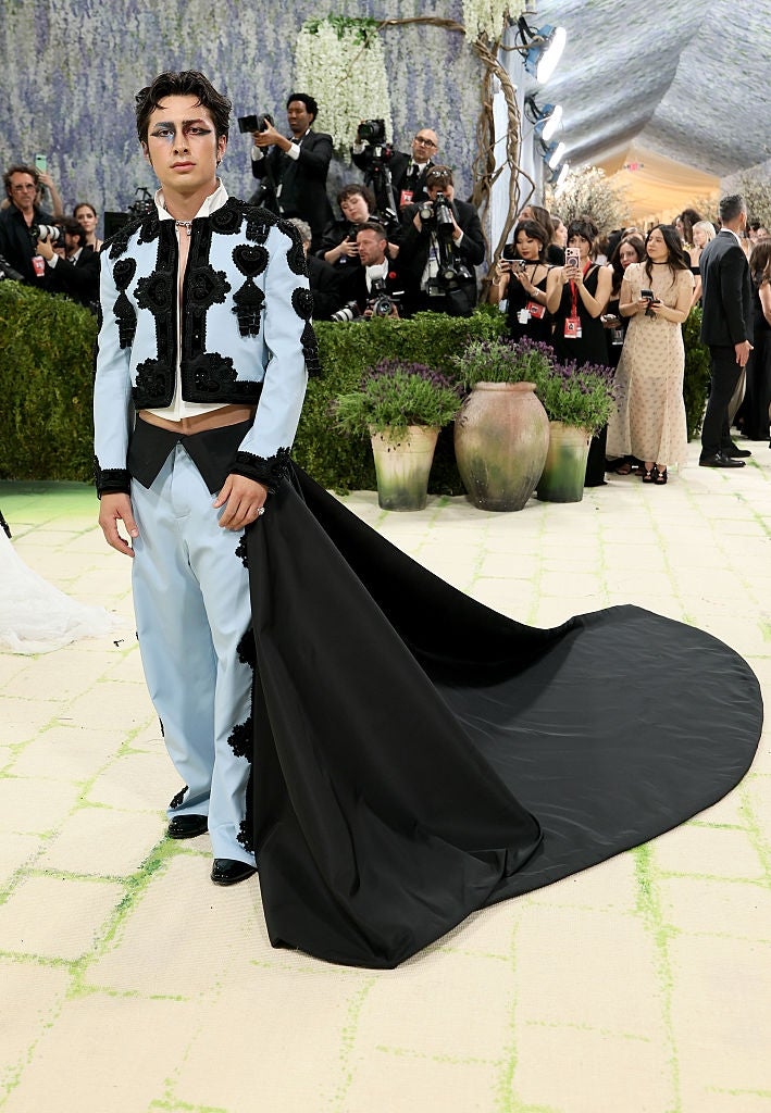 Person successful  floral-accented suit   with melodramatic  agelong  achromatic  bid     connected  a ceremonial  lawsuit   carpet
