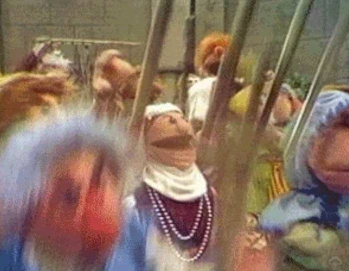Blurry puppets appear in motion, creating a chaotic and lively scene with dynamic expressions
