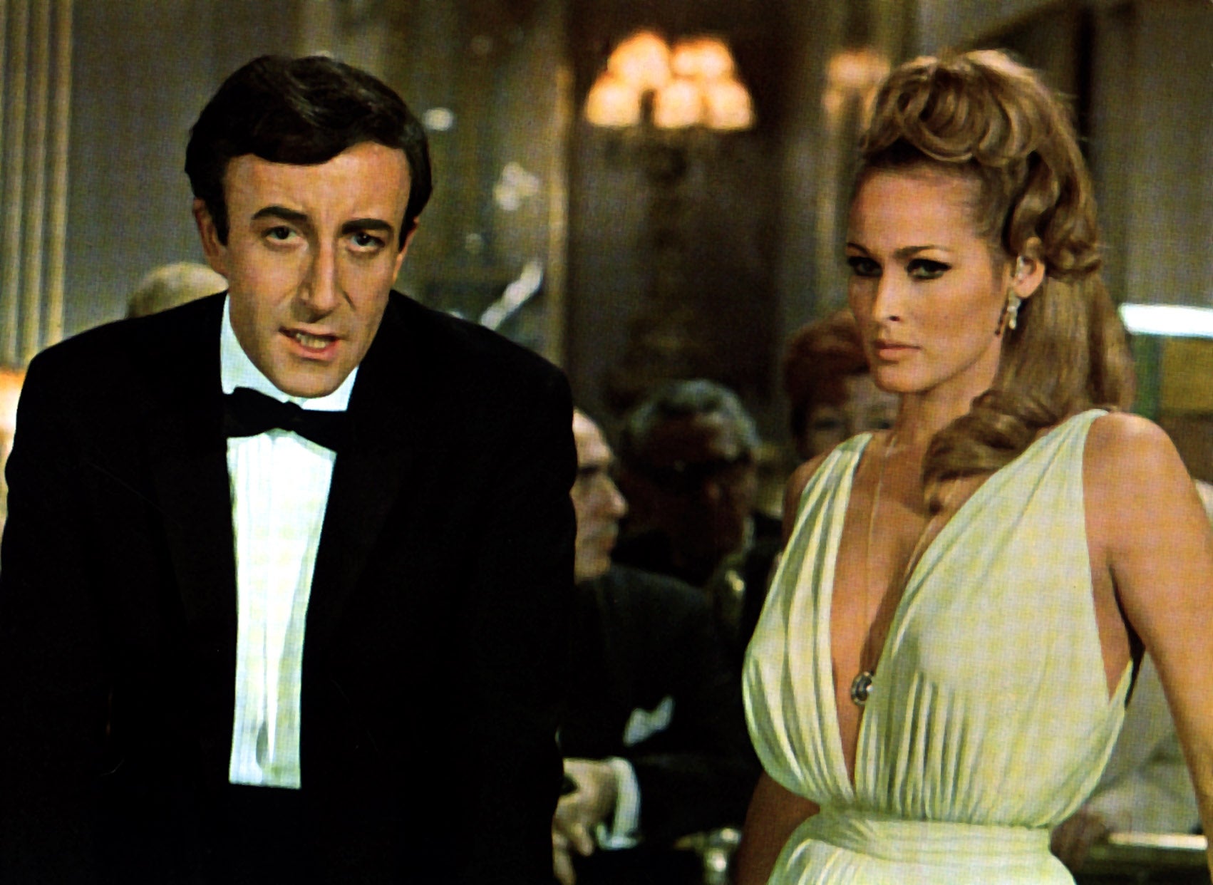 Two radical   dressed formally, with the antheral   successful  a tuxedo and the pistillate   successful  a glamorous gown, attending an elegant event