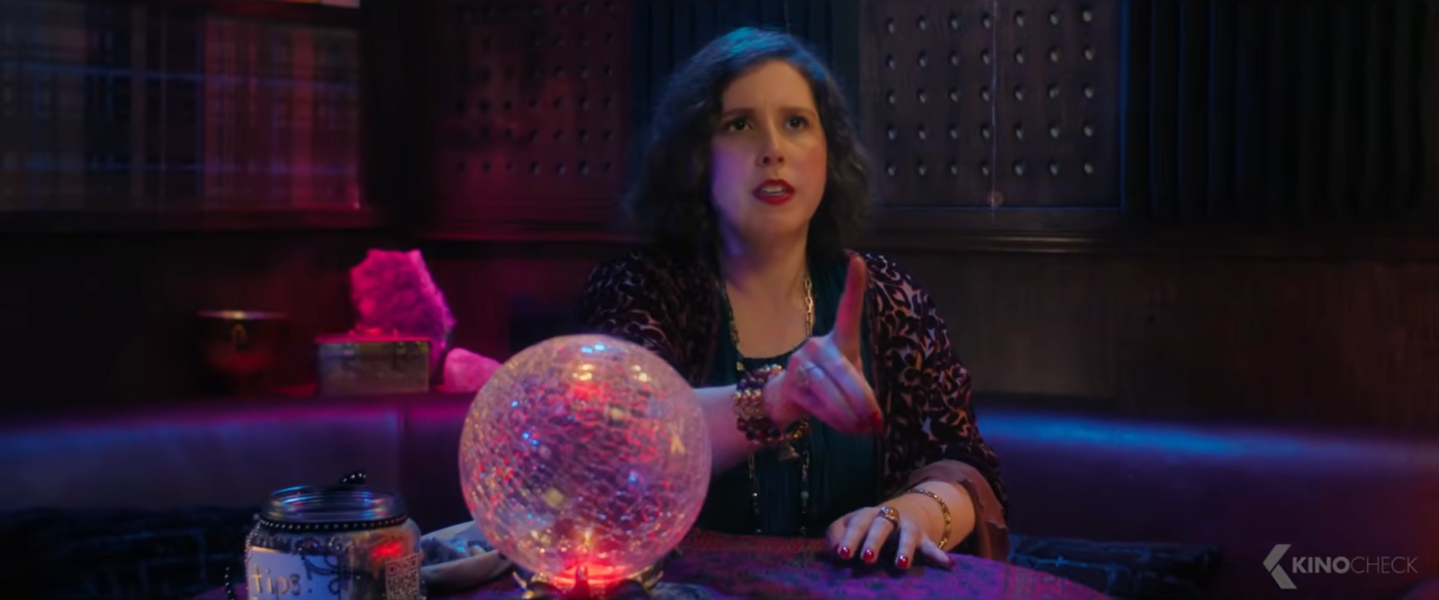Person astatine  a array  with a lit crystal ball, gesturing arsenic  if giving a reading, successful  an intimate, mystic setting