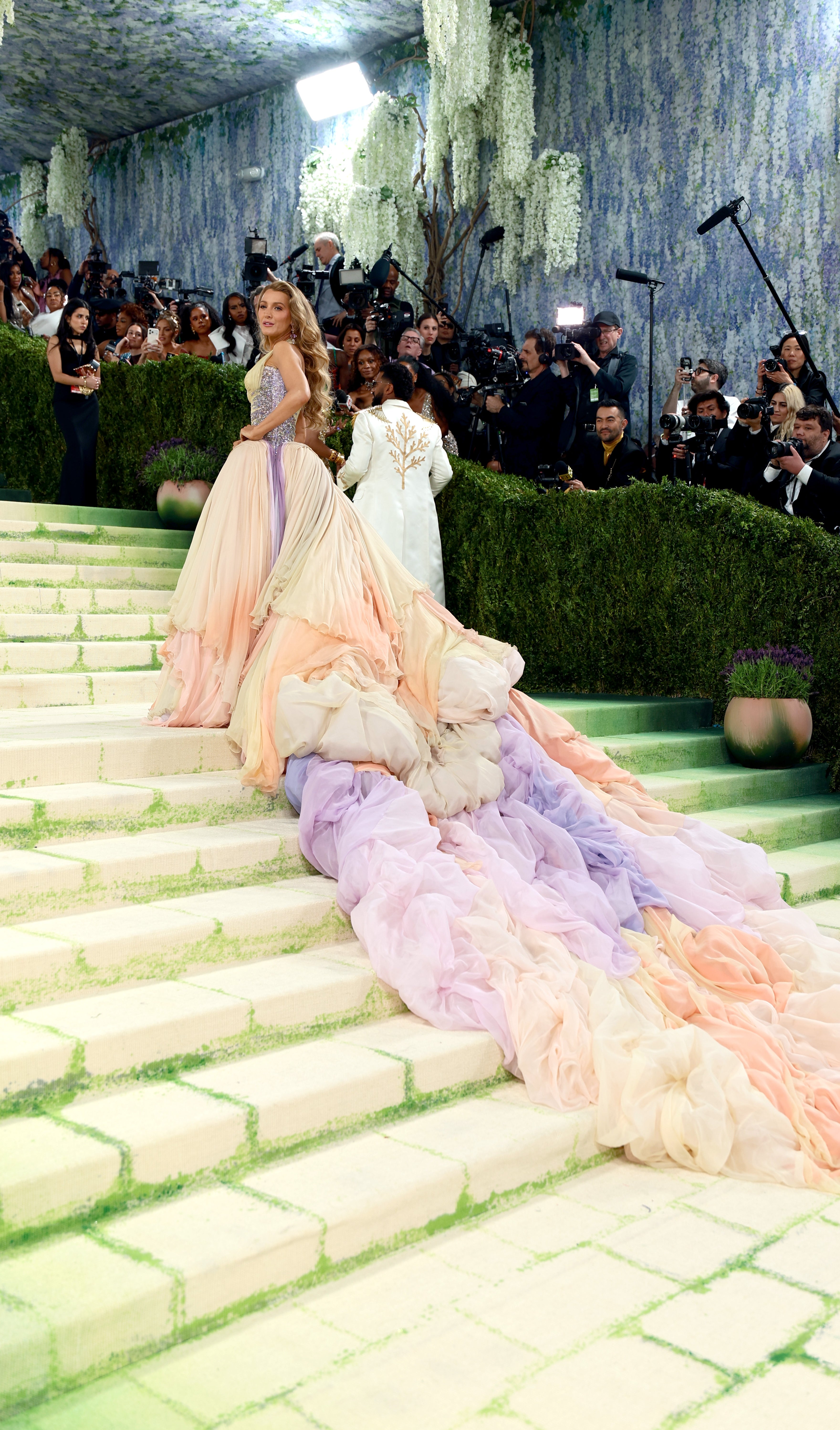Blake successful  a voluminous gown with a flowing, multicolored bid     lasting  connected  stairs astatine  the Met Gala