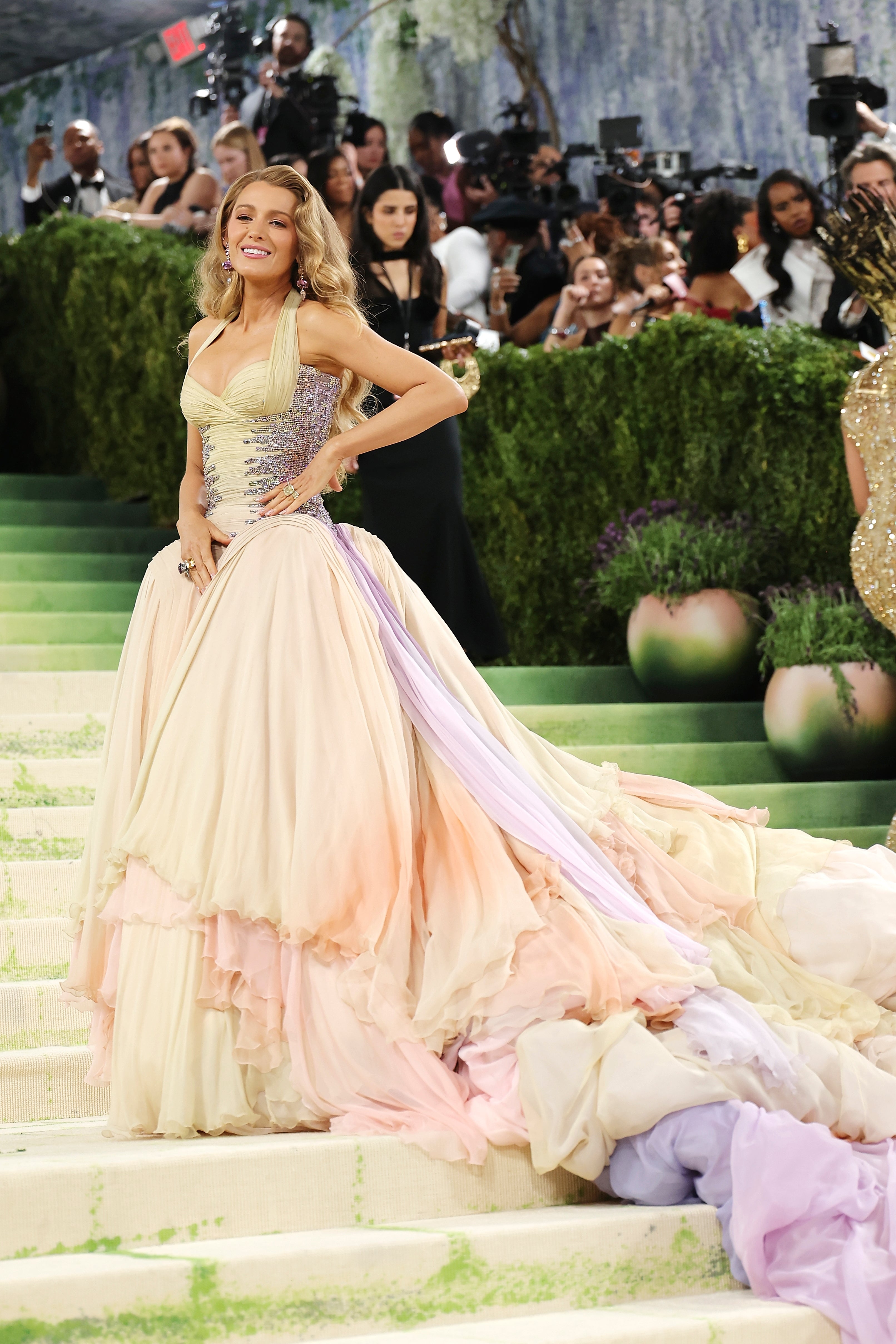 Blake successful  a flowing, voluminous gown with a fitted bodice and agelong  train