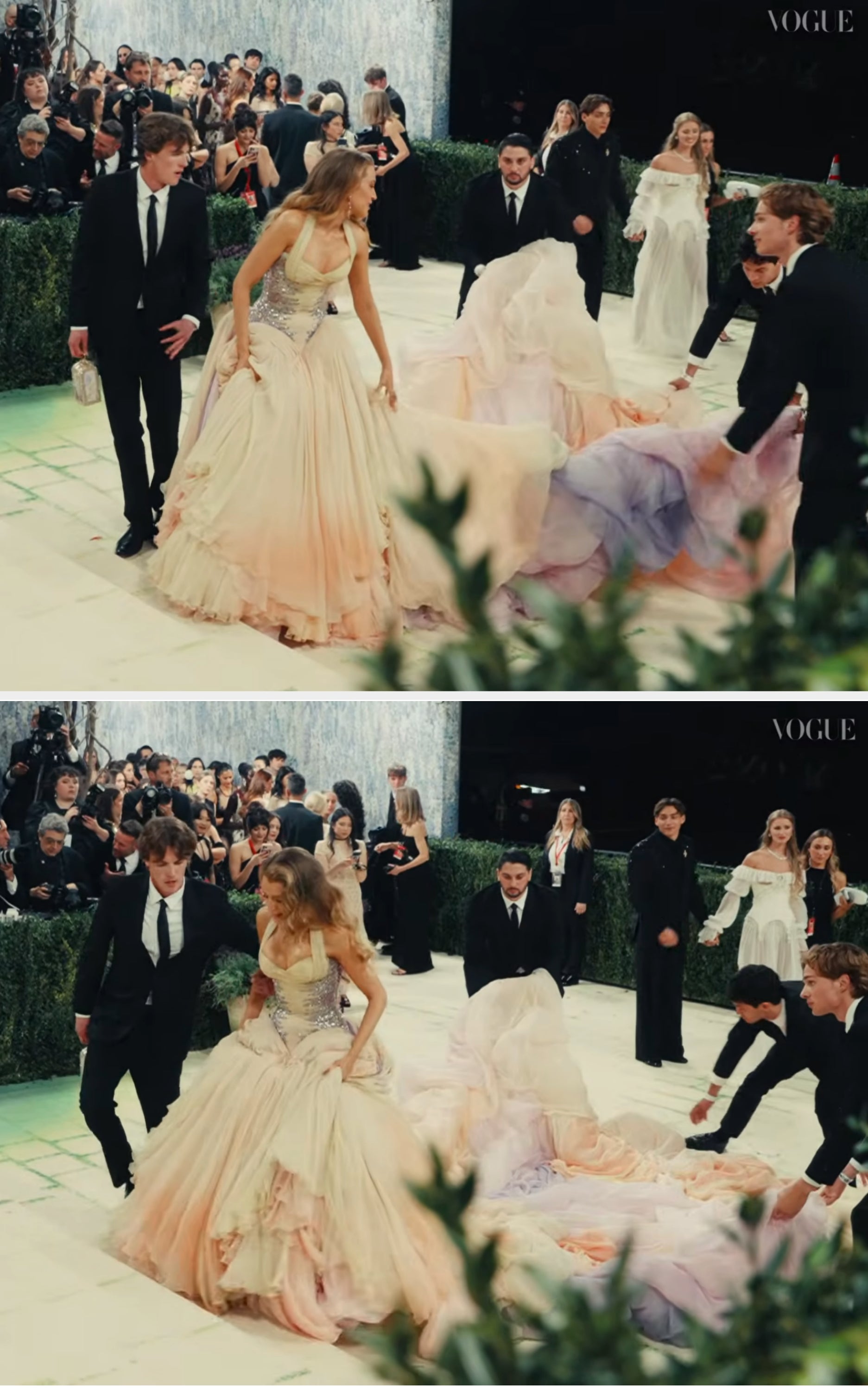 Blake successful  an elegant gown with a flowing bid     is assisted by attendants connected  a reddish  carpet, with photographers capturing the scene