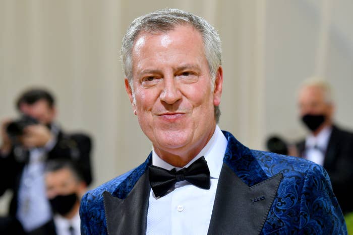 Person successful  a patterned tuxedo overgarment   and bow necktie  connected  a ceremonial  lawsuit   carpet, with photographers successful  the background