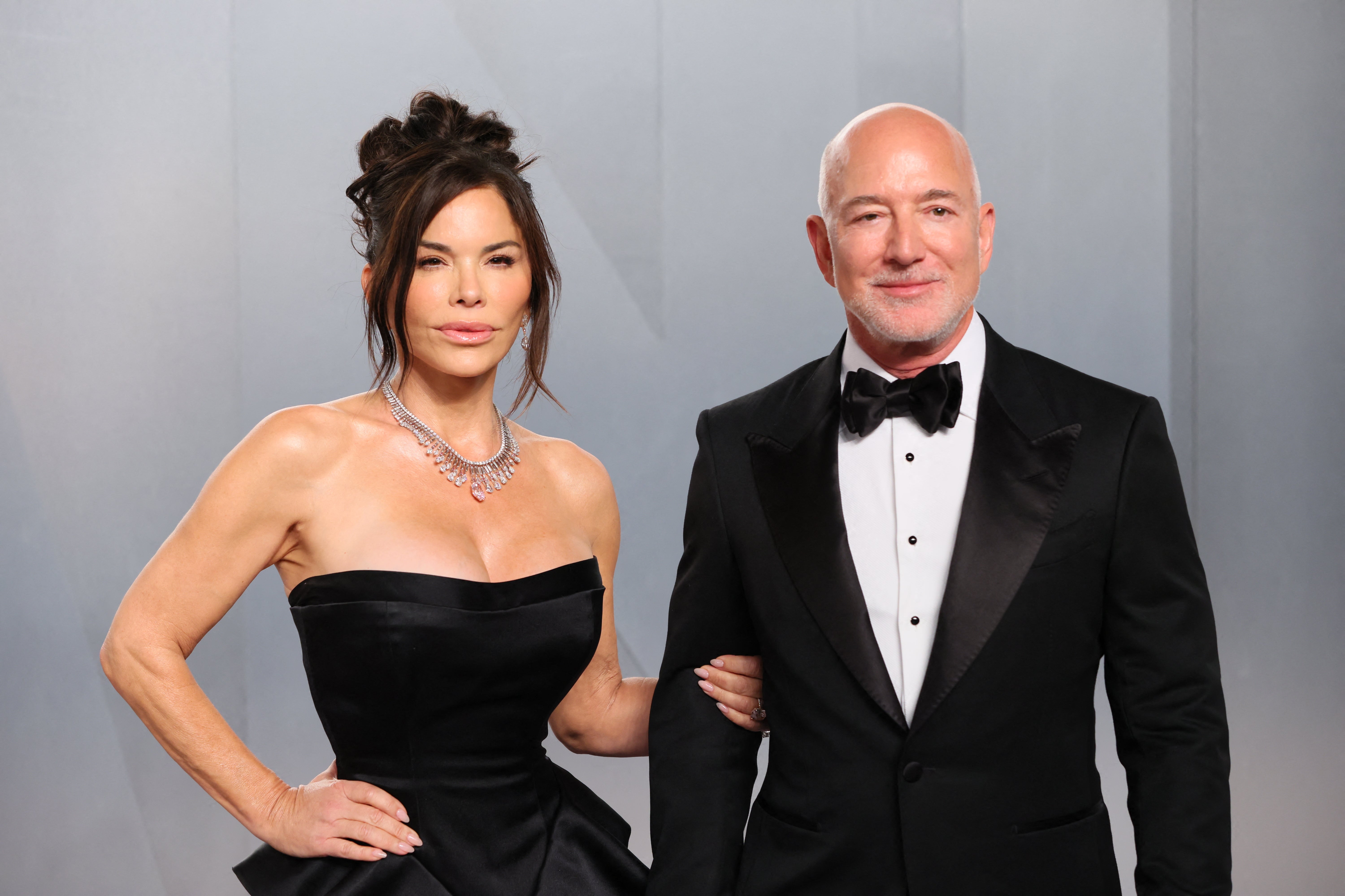 Two individuals successful  ceremonial  attire connected  a reddish  carpet; pistillate   successful  a strapless gown, antheral   successful  a tuxedo