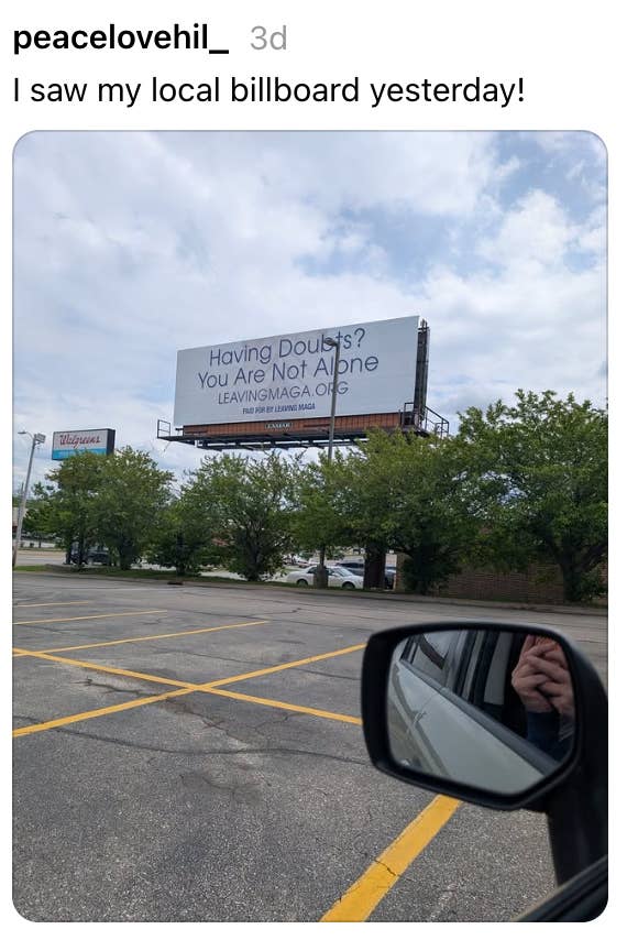 View from a car   model   of a billboard reading, "Having Doubts? You Are Not Alone LEAVINGAGA.ORG." Bright day, parking batch  scene