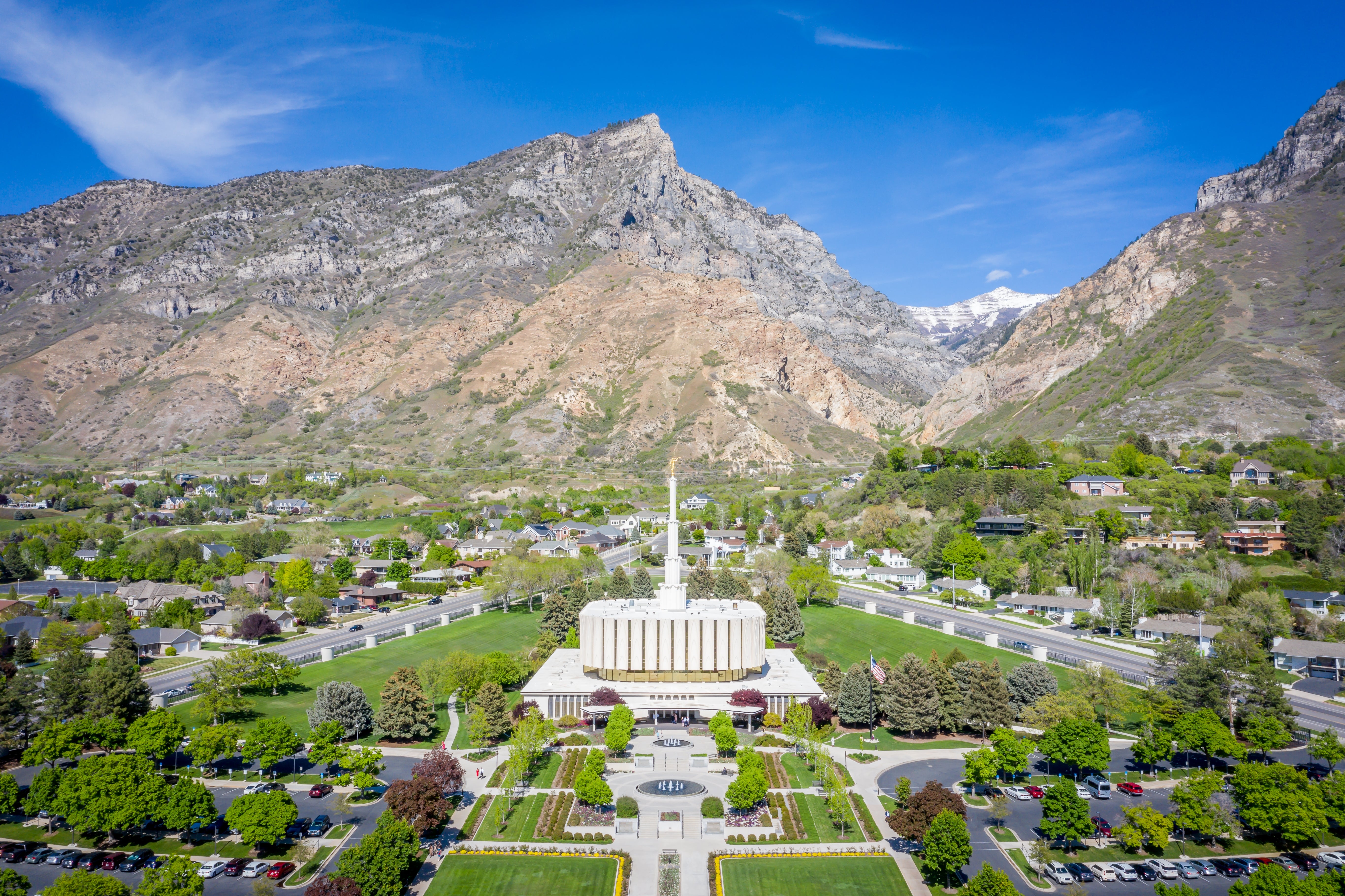 Aerial presumption    of a ample  temple with a spire, surrounded by greenery, acceptable   against a backdrop of mountains