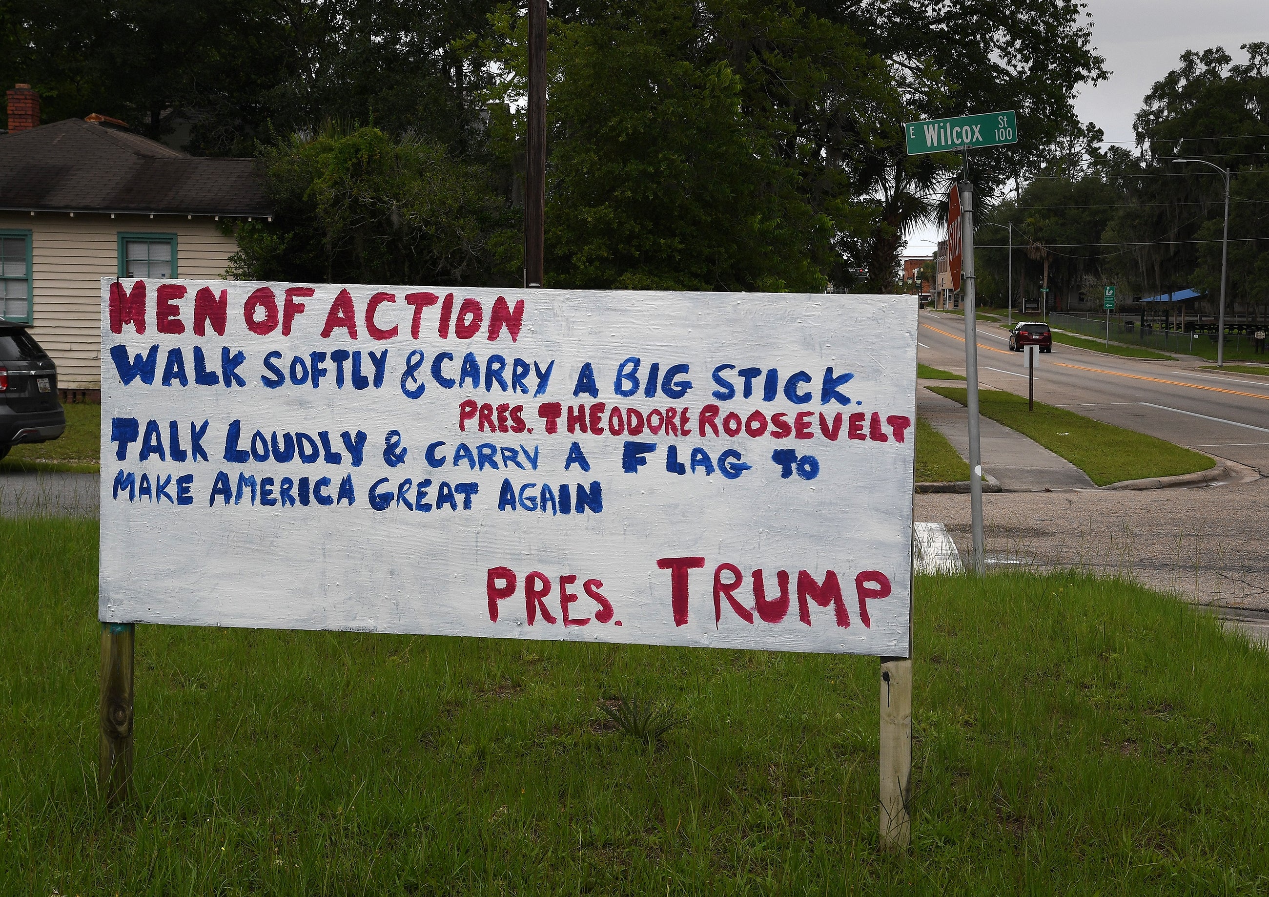 Large handmade motion   features quotes from Theodore Roosevelt and Donald Trump astir  carrying a large  stick/flag, aims to animate  action