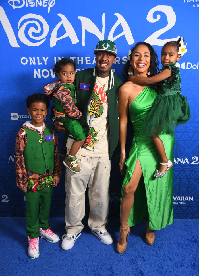 A household  poses astatine  a "Moana 2" event. The adults are successful  casual chic attire and the children deterioration  coordinated outfits with amusive  patterns