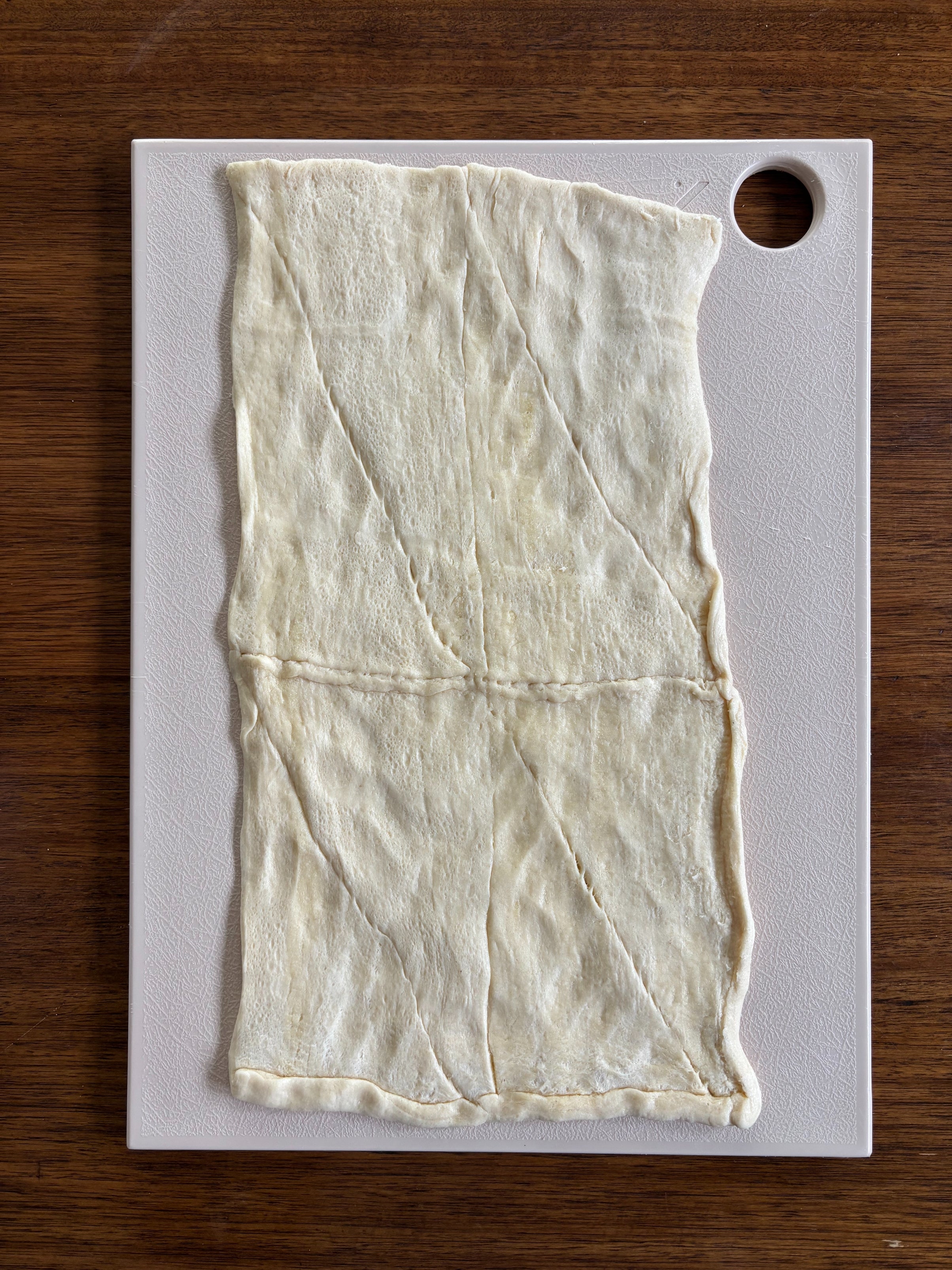 Pastry dough rolled out on cutting board