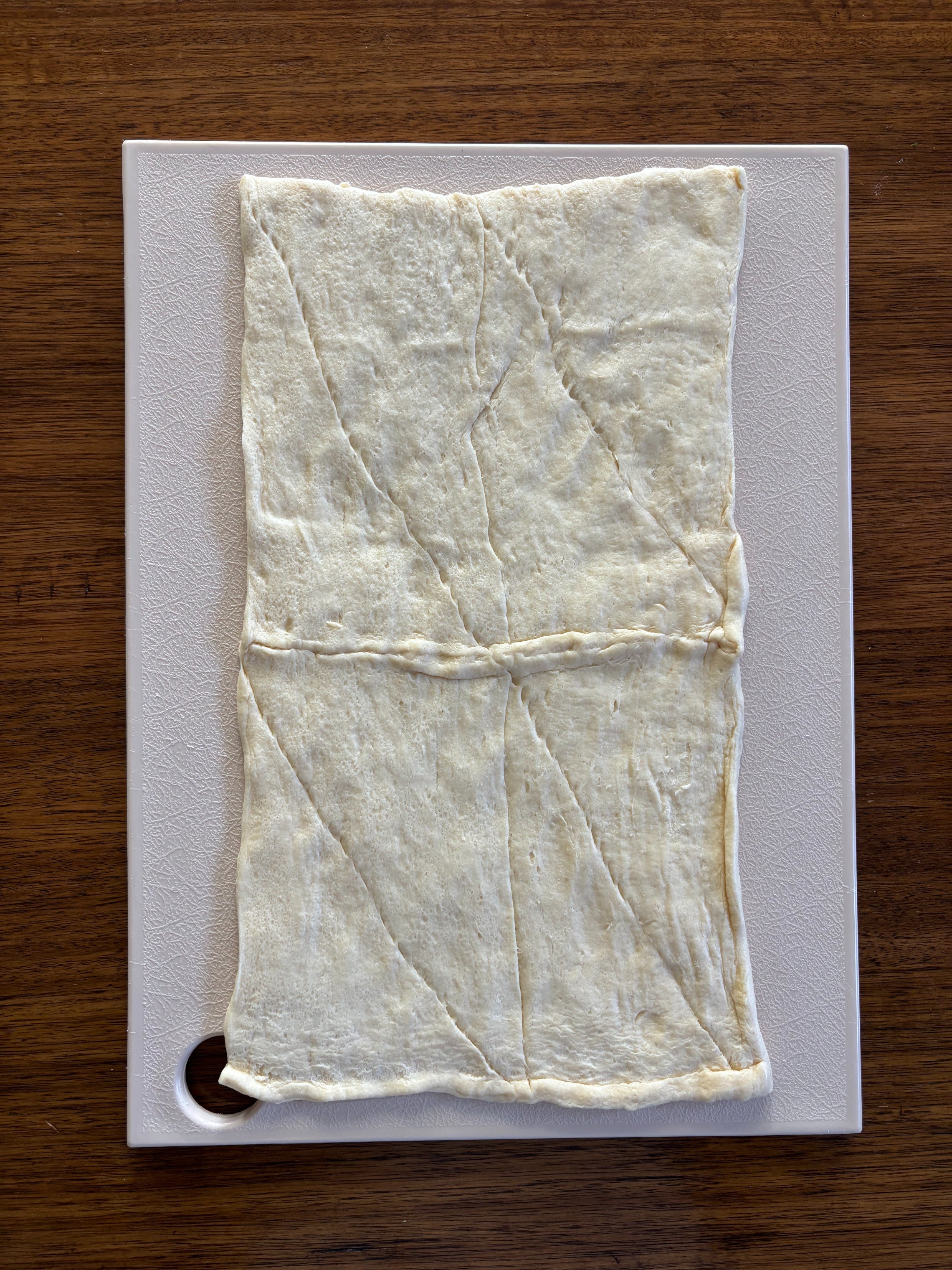 Unbaked sheet of pastry dough laid flat on a cutting board
