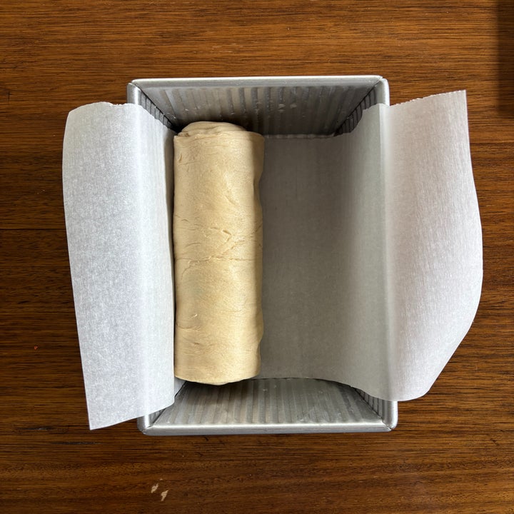 Dough log placed in a parchment-lined loaf pan