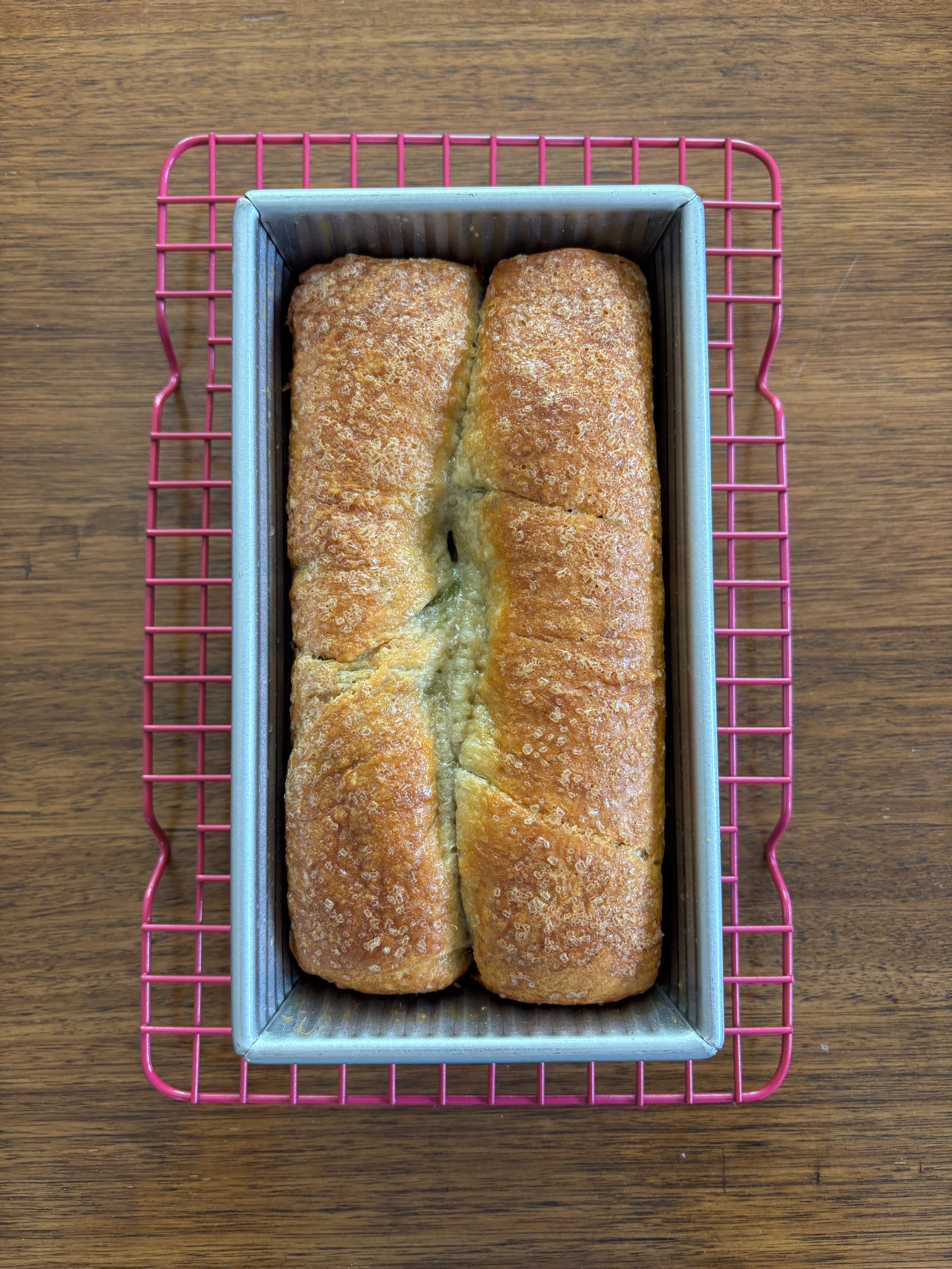 Bread in a loaf pan on a cooling rack