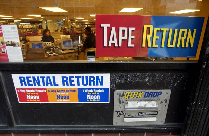 Storefront with "Tape Return" motion   and rental instrumentality    slots for antithetic  durations. "QUIK DROP" slot is disposable   connected  the door