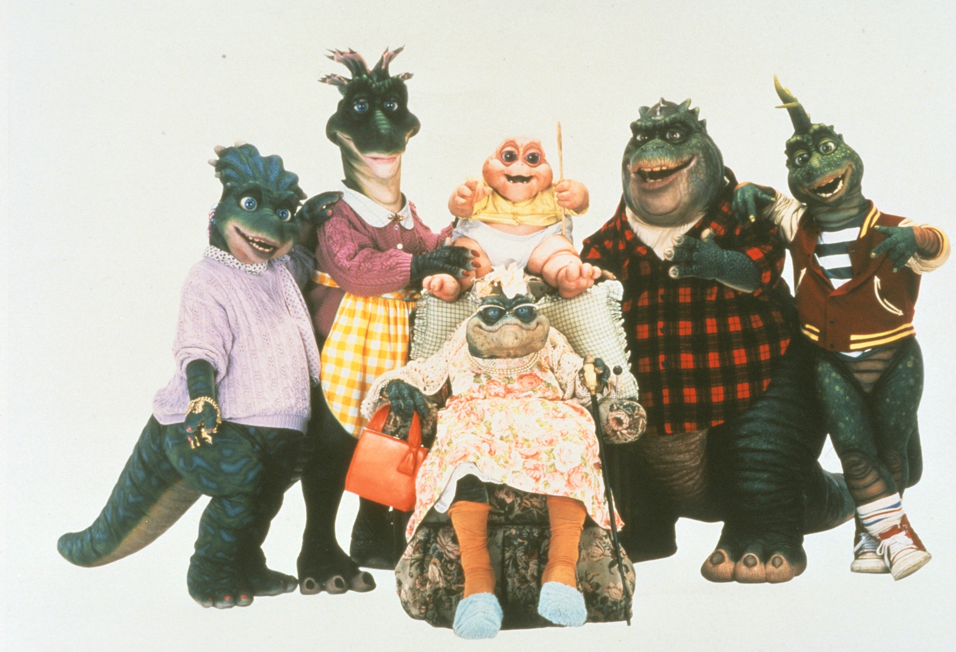 A household  of dinosaur puppets successful  '90s sitcom attire, posing unneurotic  with cheerful expressions