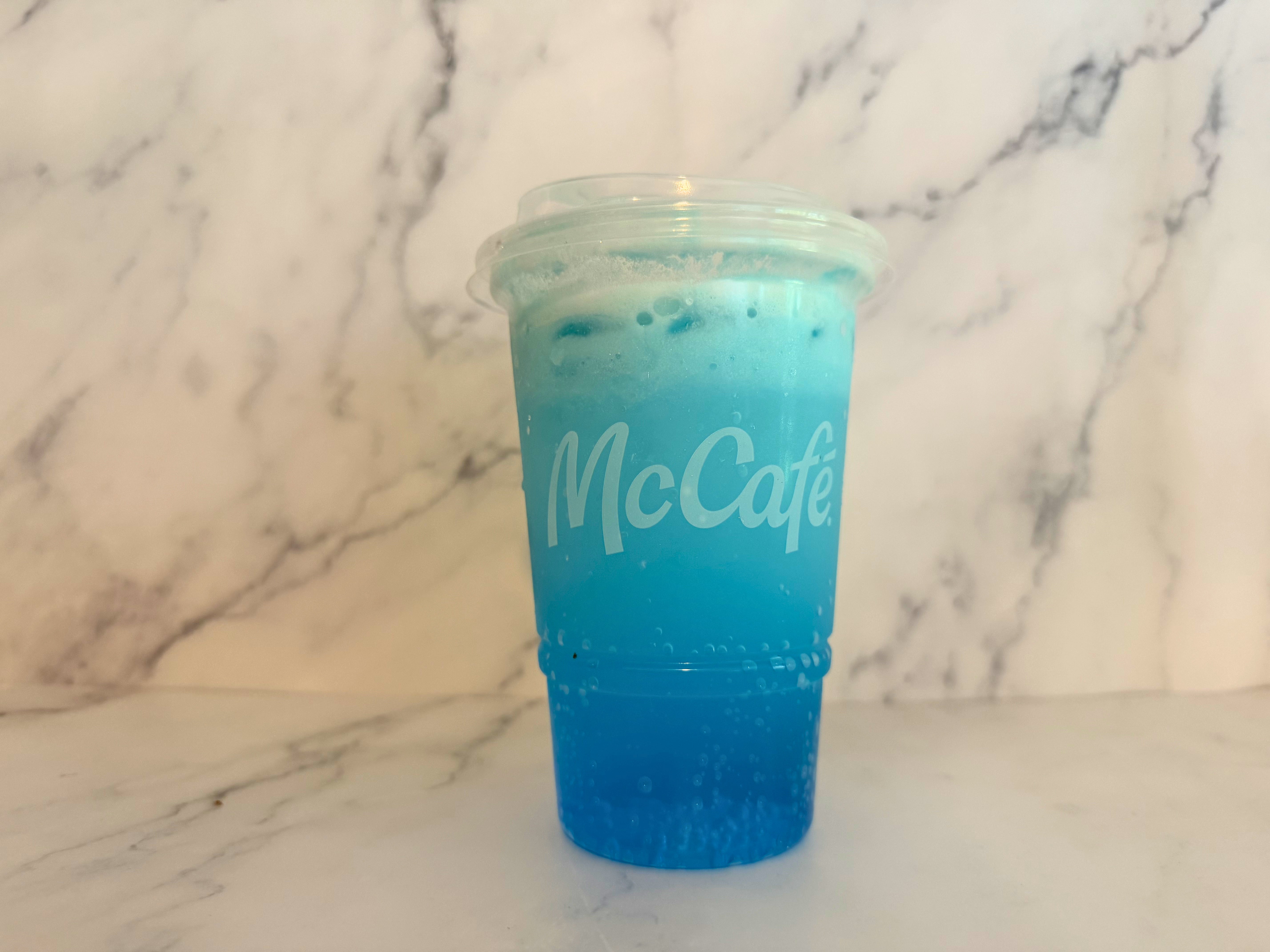 Sprite Berry Blast in a clear cup labeled "McCafé" on a marble surface