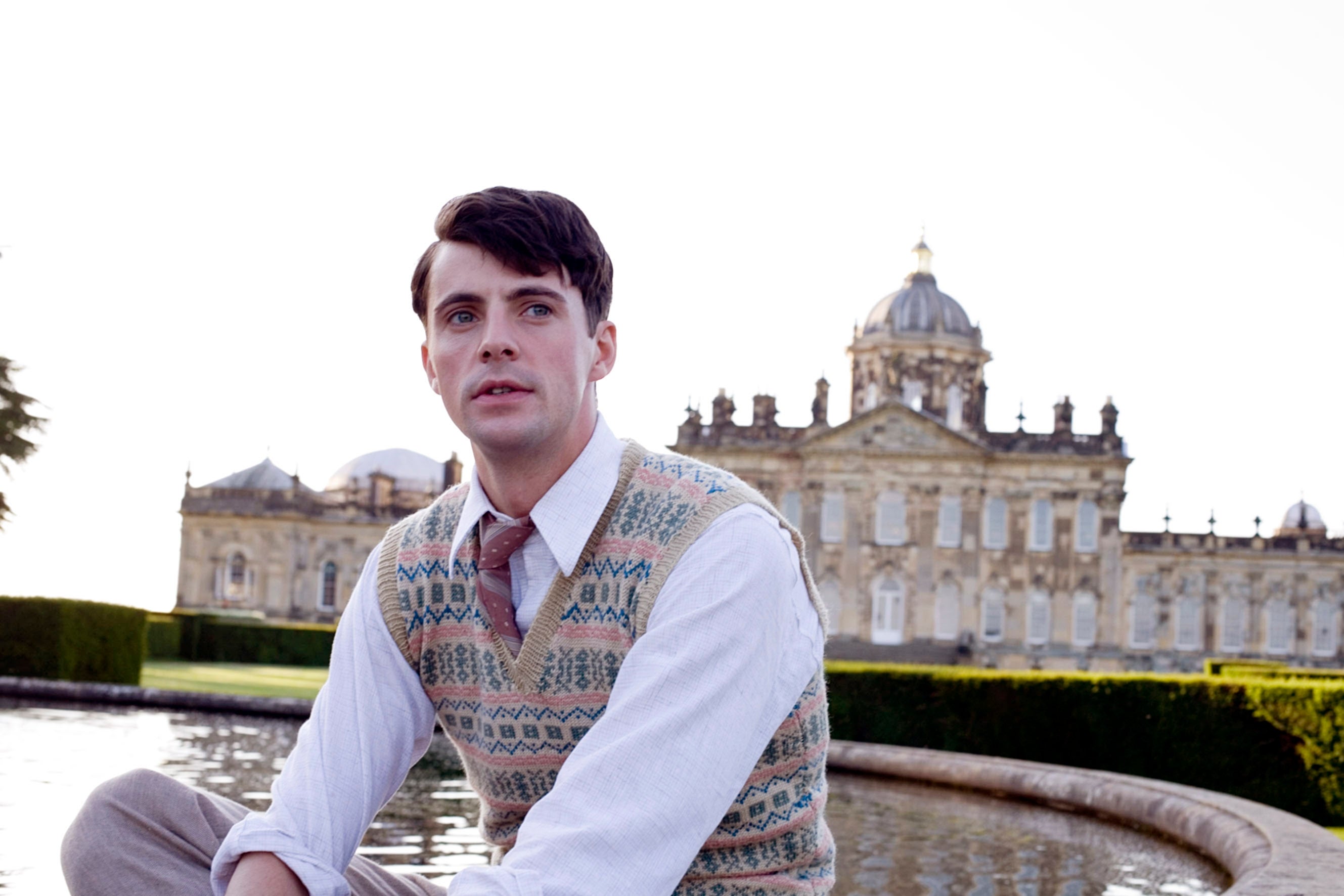 Person successful  vintage attire sits by a fountain, with an ornate gathering  successful  the background